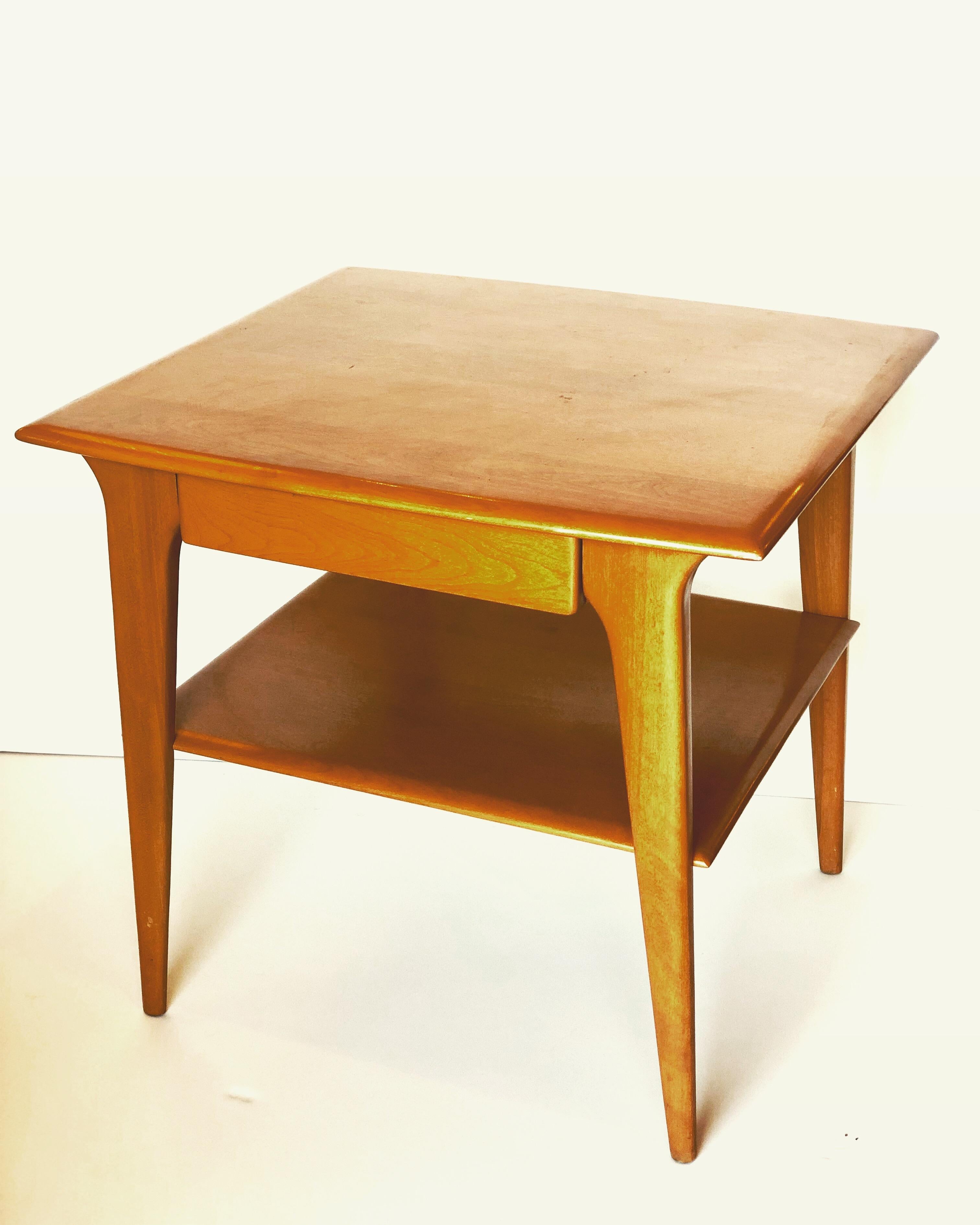 Beautiful tall table by Heywood Wakefield, circa 1950s freshly refinished in a honey color solid and sturdy elegant legs represents the Atomic age at full splendor.