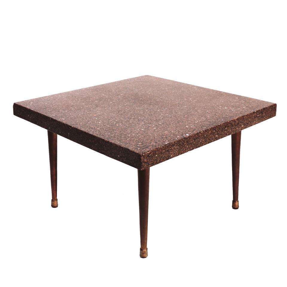 American Mid-Century Modern terrazzo end table with a top surface of molded and polished composite brown-toned crushed granite and black resin background, in a square shape with four tapered wood legs and gold painted leg caps,
circa