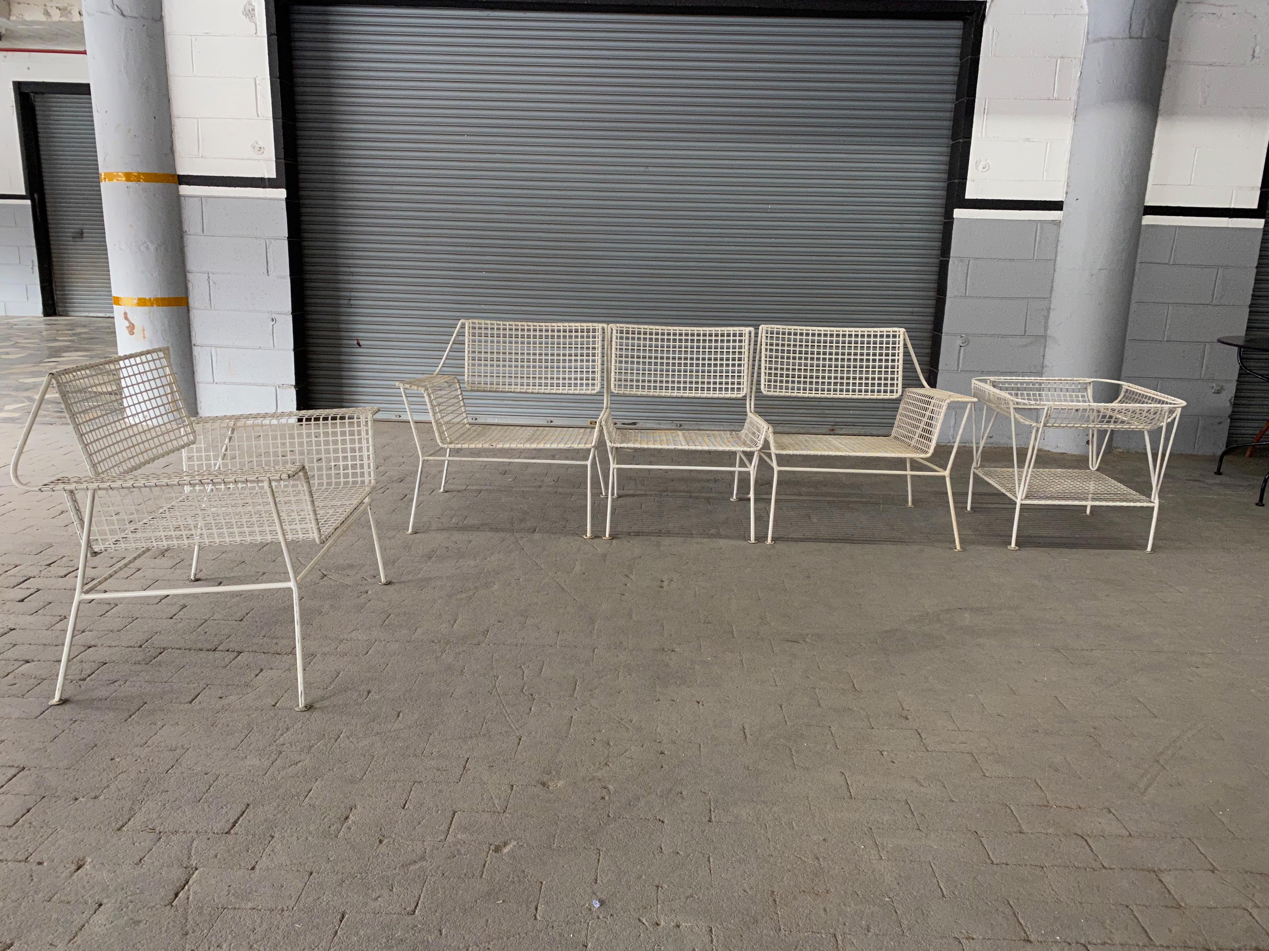 American Mid-Century white iron garden settee in three separate pieces. Very good vintage condition, would be even better with colorful cushions.    Part of a larger set that includes an armchair, a three piece settee, and an end table.
 


