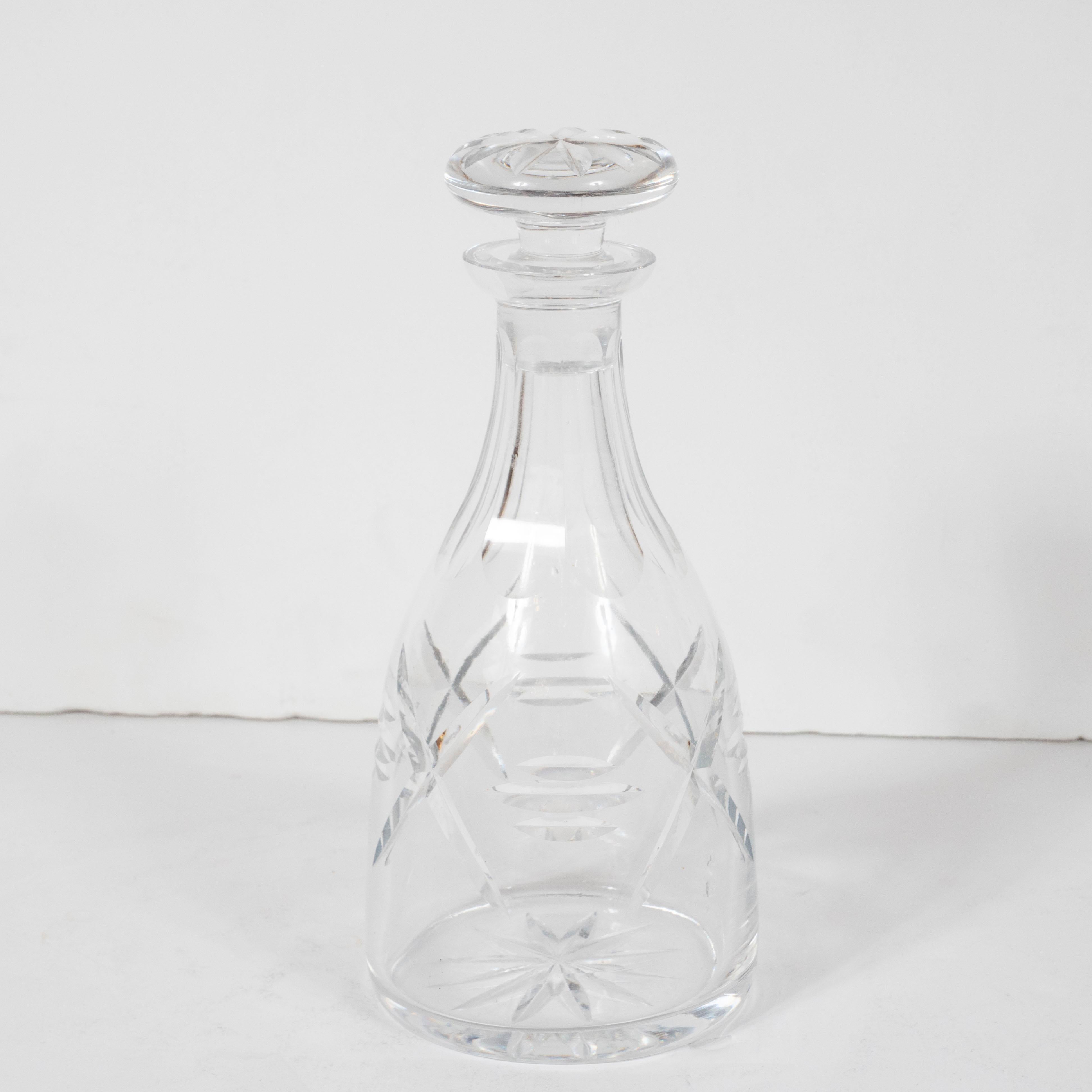 This refined Mid-Century Modern decanter was realized in the United States, circa 1950. Realized in translucent glass with geometric forms incised into the exterior, this piece is as visually pleasing as it is functional. It would be an excellent