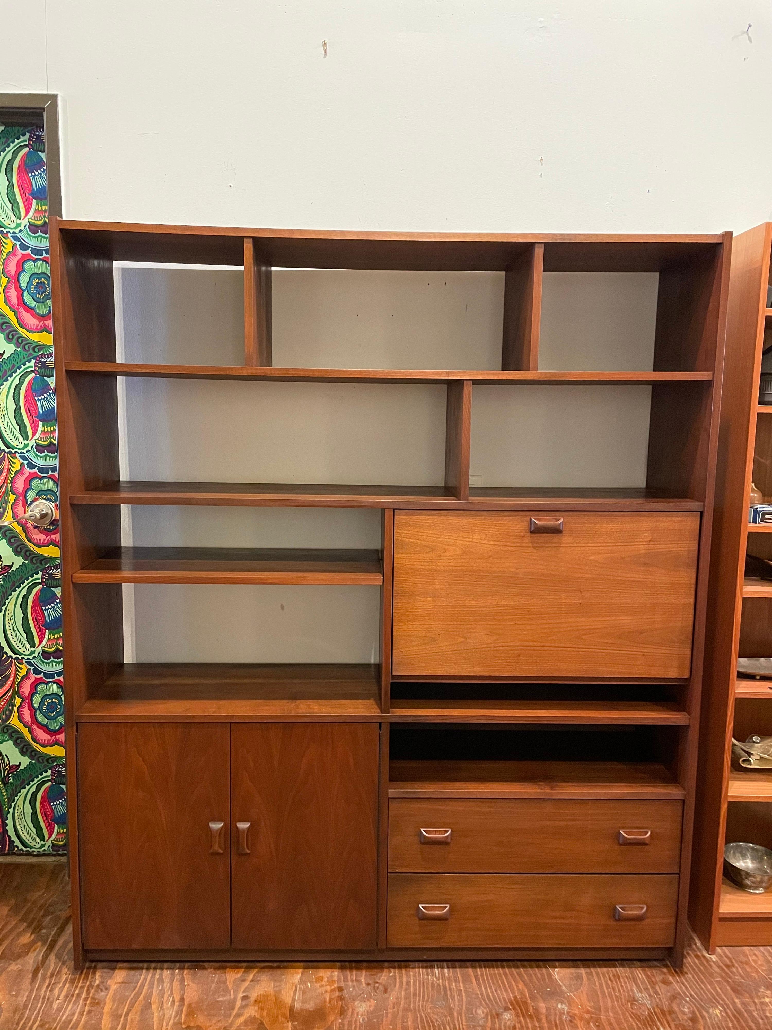 Versatile multiuse walnut bookcase, desk wall unit circa 1960's nice original condition we have cleaned and oiled this piece with one removable shelf drawers desk bar etc.