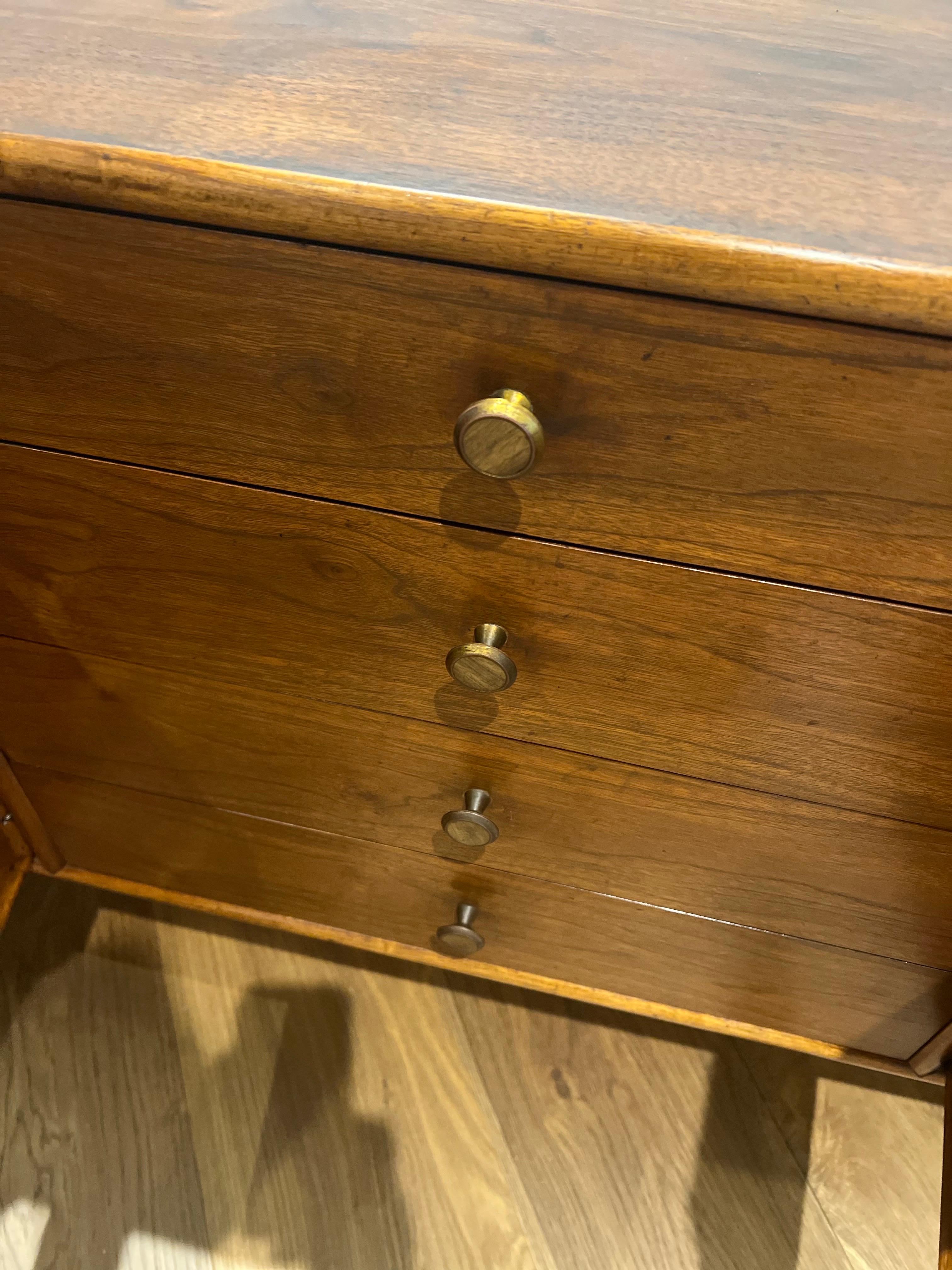 Mid-Century Modern credenza designed by Kipp Stewart & Stewart MacDougall for Drexel’s “Declaration” line in the United States, circa 1950s. This credenza features a walnut wood frame accented with the original signature brass & walnut center pulls