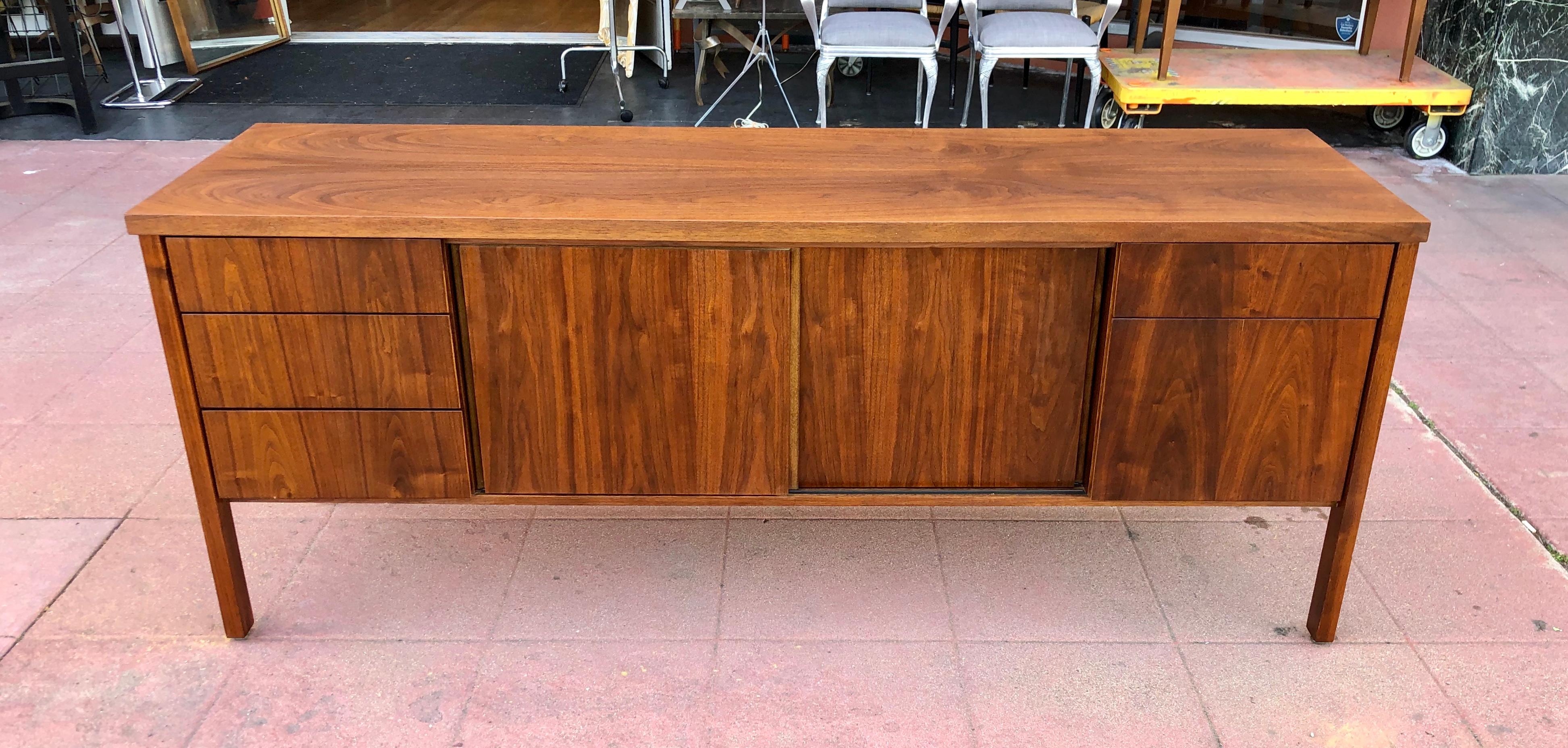 A simple elegant American walnut office credenza, circa 1960s great condition very clean we have oiled and light finish the piece, great construction lots of storage and file drawer. Beautiful wood grain.