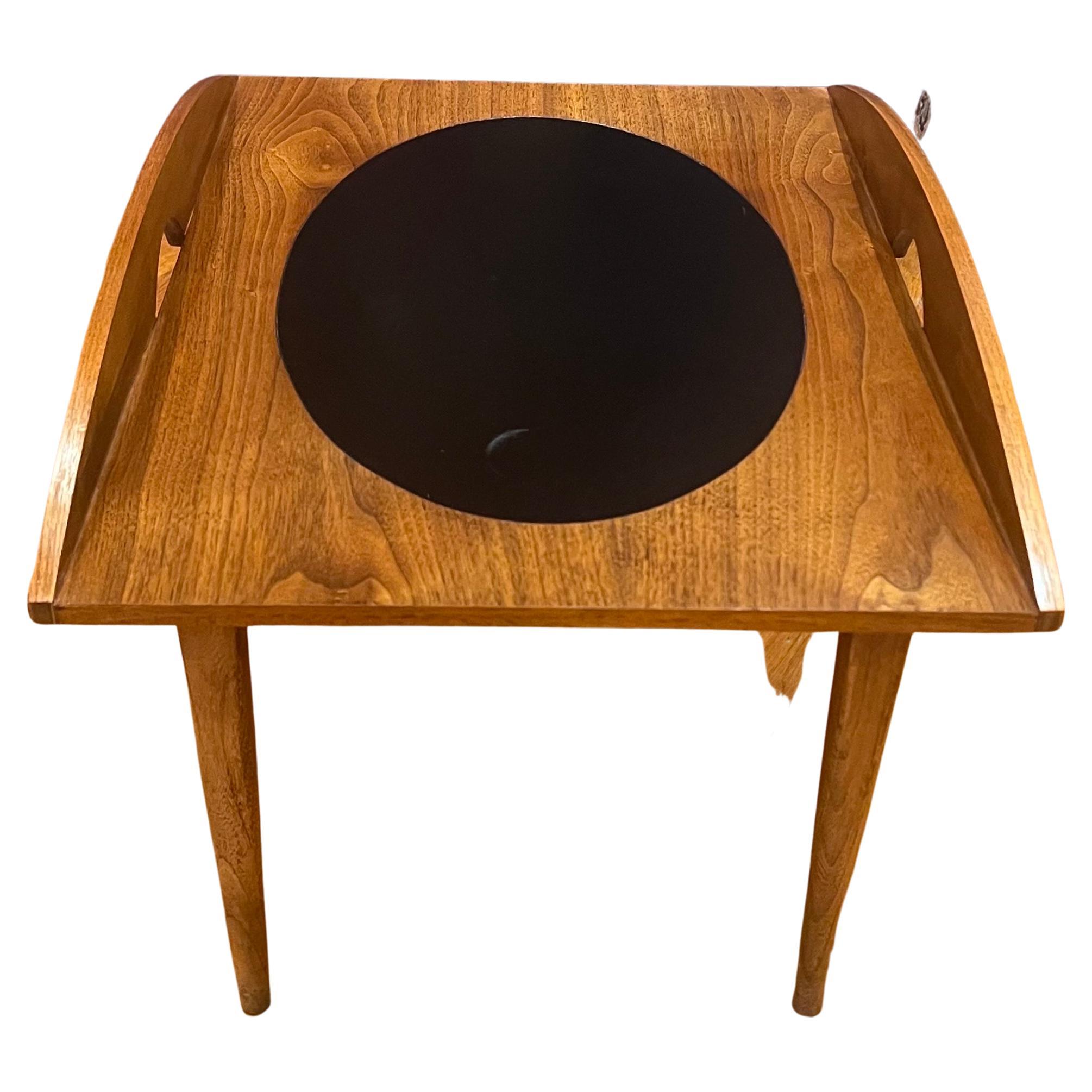 Very rare small butler table was designed by Paul McCobb for Lane, circa the 1960's versatile and elegant with a leather oval top walnut top, and elm wood base.
