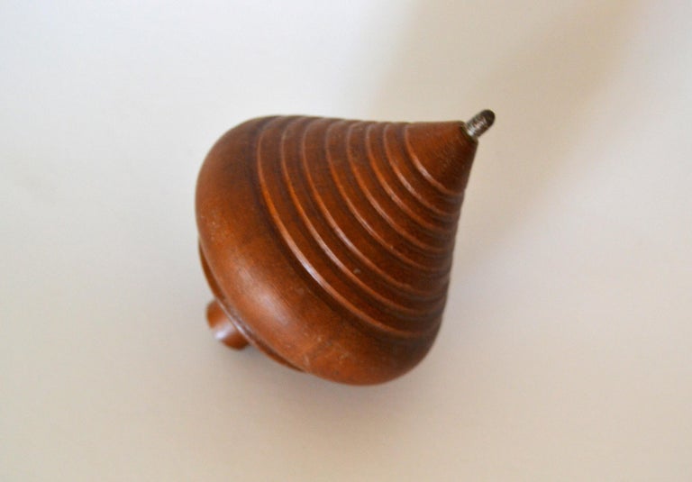 Mid-Century Modern American craftsman woodworking turned walnut wood spinning top toy. This is a collectible fun toy.
