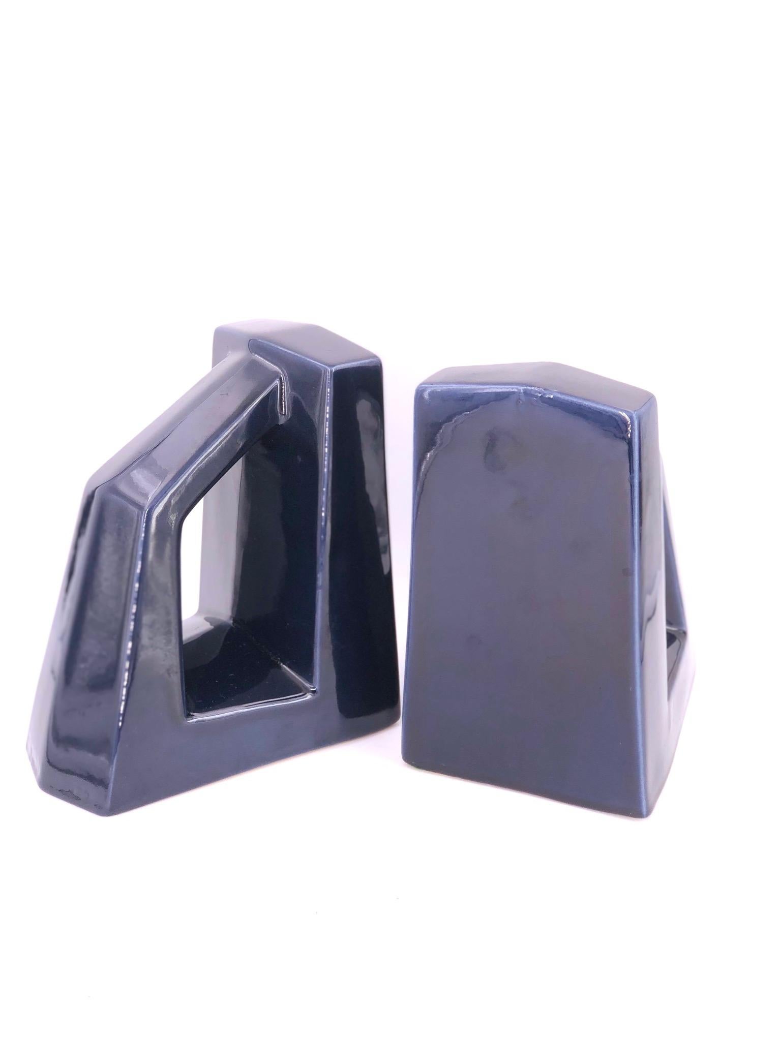 Art Deco style rare pair of ceramic bookends by Jaru circa 1960s in a navy blue glossy finish. Stamped at the bottom and retains the original label, one of the bookends presents a repair of a chip as shown in the picture. Item sold AS/IS.
