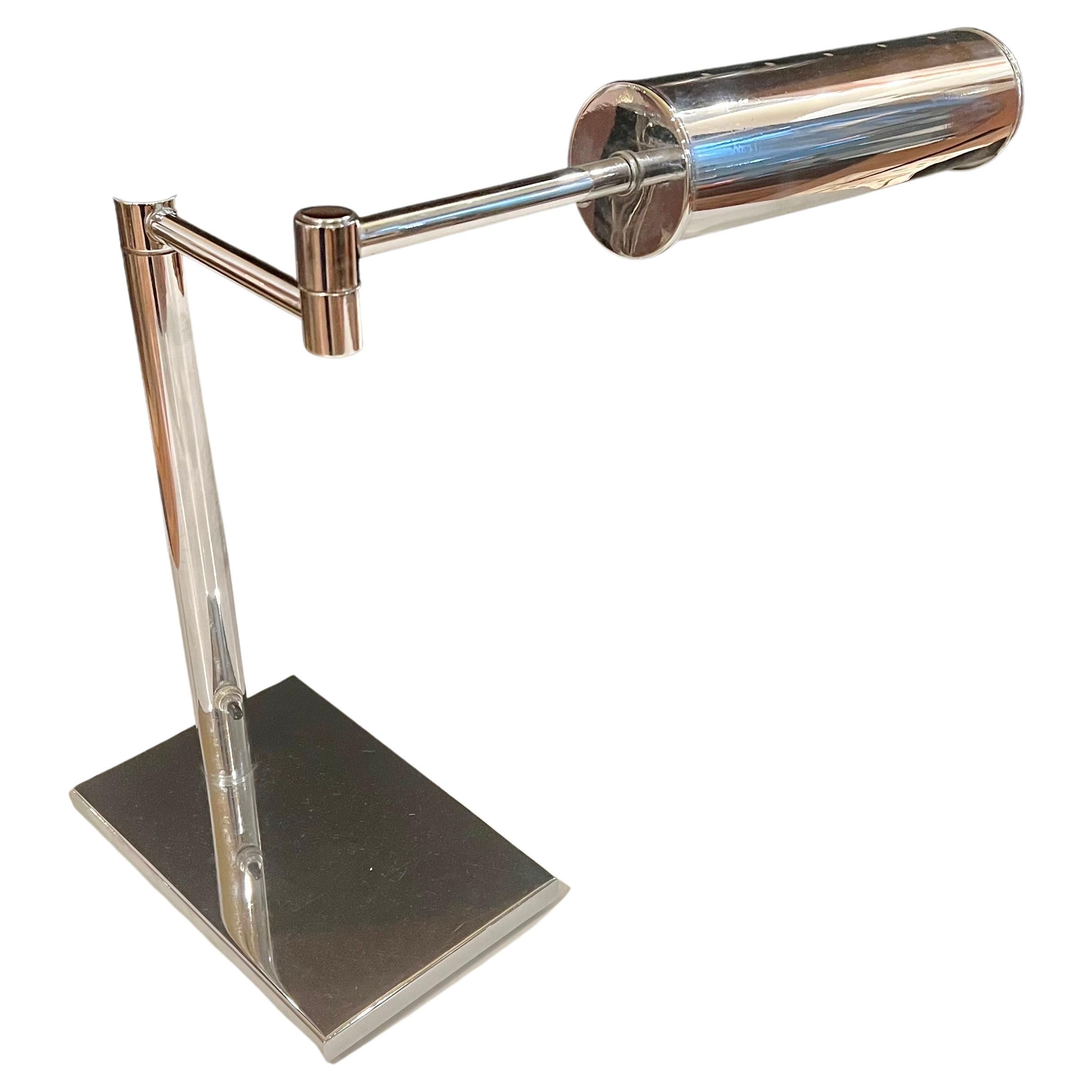 Beautiful and rare multidirectional desk lamp by Nessen Studios in chrome finish and steel, with perforated shade shown that rotates side to side, and the classic Nessen arm retractable system.