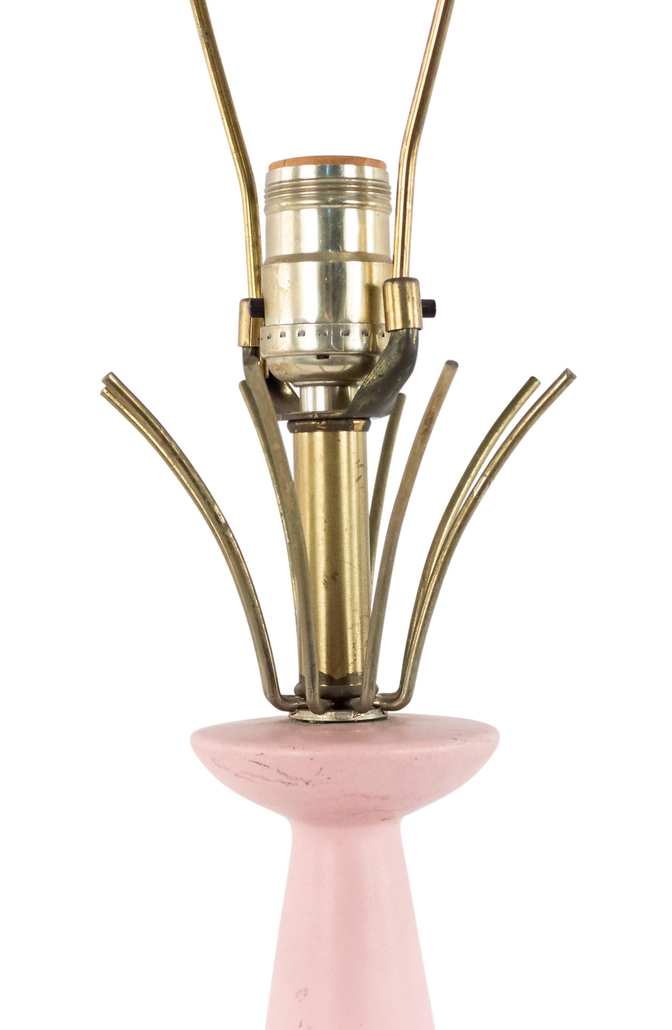 American Mid-Century pink porcelain cone shaped table lamp with a round brass base and brass spokes at top.