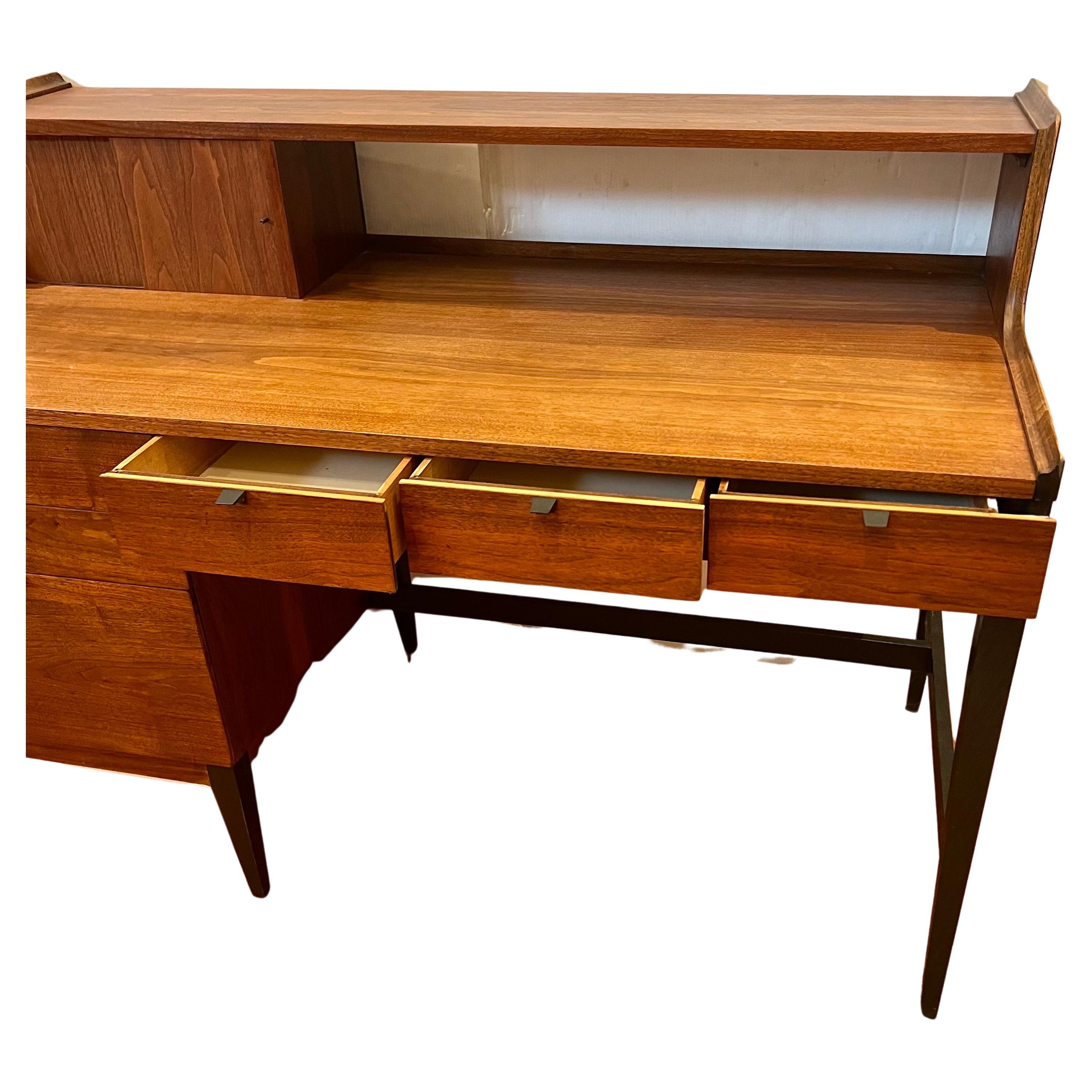 Beautiful and rare tall desk secretaire by Cavalier designed by Arthur Umanoff, circa 1950's in walnut finish with black lacquer accents, freshly refinished lost of storage plenty of drawers, hard to find.