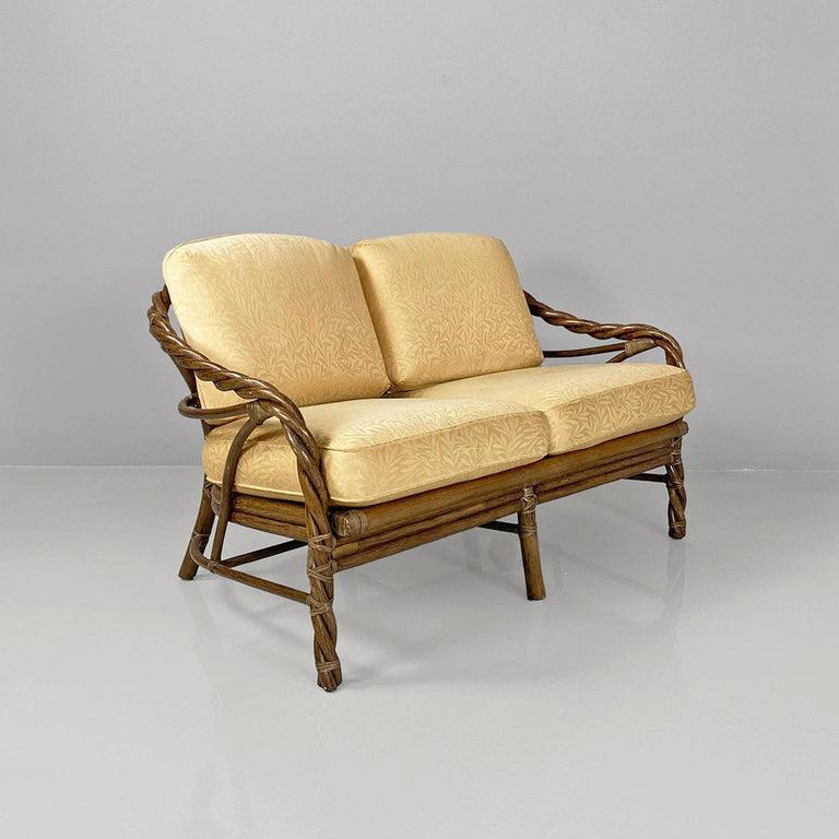 American modern rattan and beige floreal fabric sofa by McGuire Company, 1970s.
Two-seater sofa with seat and back made by cushions upholstered in beige fabric with floral motifs. The structure, armrests and legs are made of woven rattan with