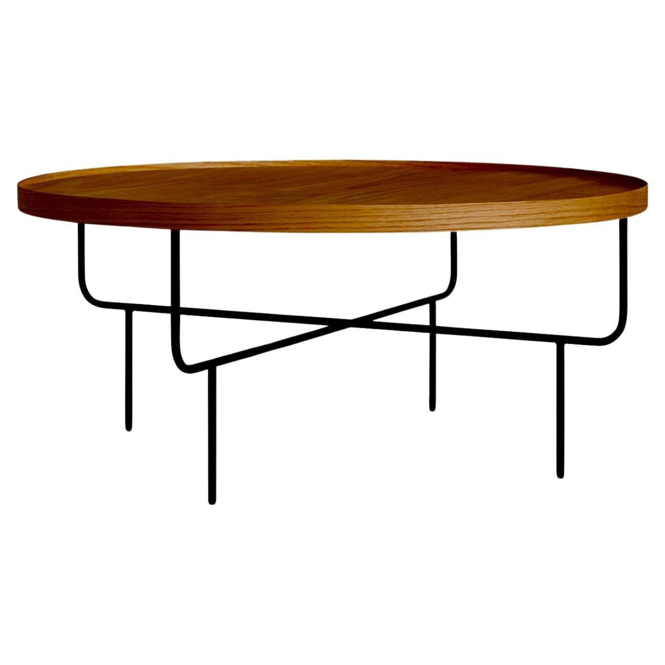 Shatter the status quo or just have a place to set your drink down. Wood on top. Wire on the bottom. Functional eye pleasing magic everywhere. American Mid Century minimalist round coffee table with raised edge and solid iron black enameled