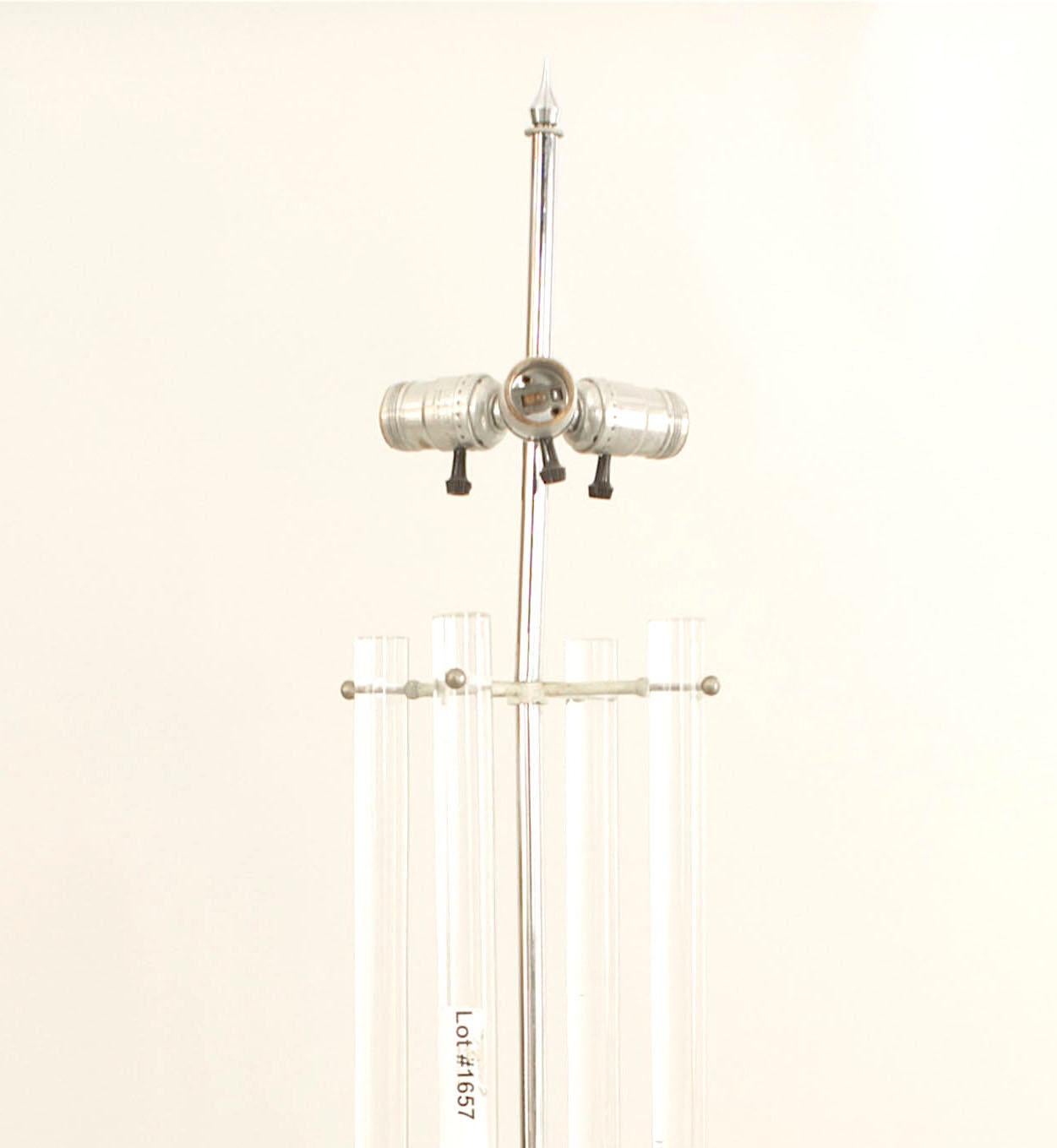 American midcentury table lamp with 4 tubular Lucite arms supported on a chrome stand and Centerport resting on a black cube base (att: PARZINGER)

Tommi Parzinger, born in 1903, was a German furniture designer and painter. He had begun by