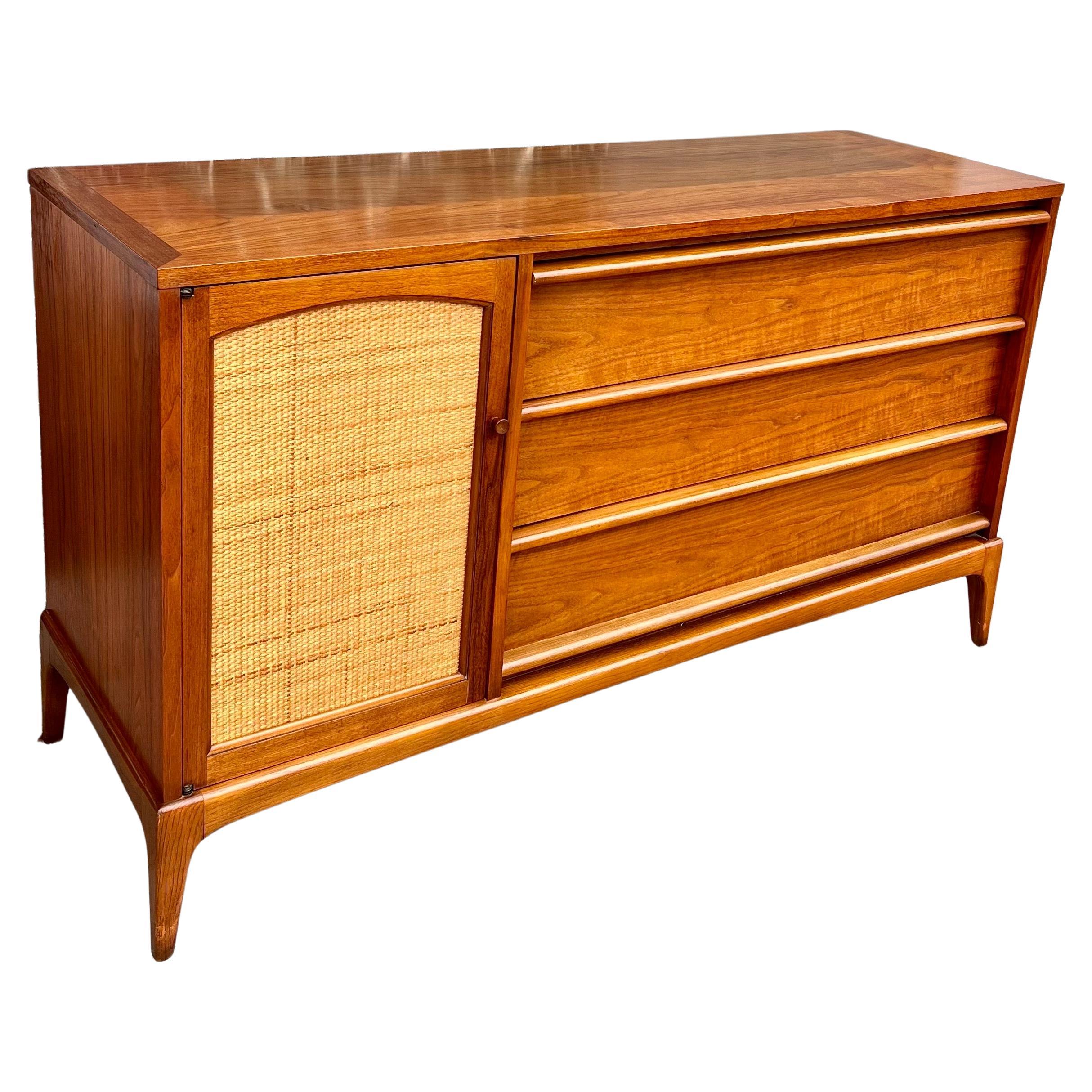 American Mid Century walnut credenza circa 1950's , with reversible front dorr cane & solid walnut as shown the piece has its original finish very clean we oiled the credenza its in very clean condition.