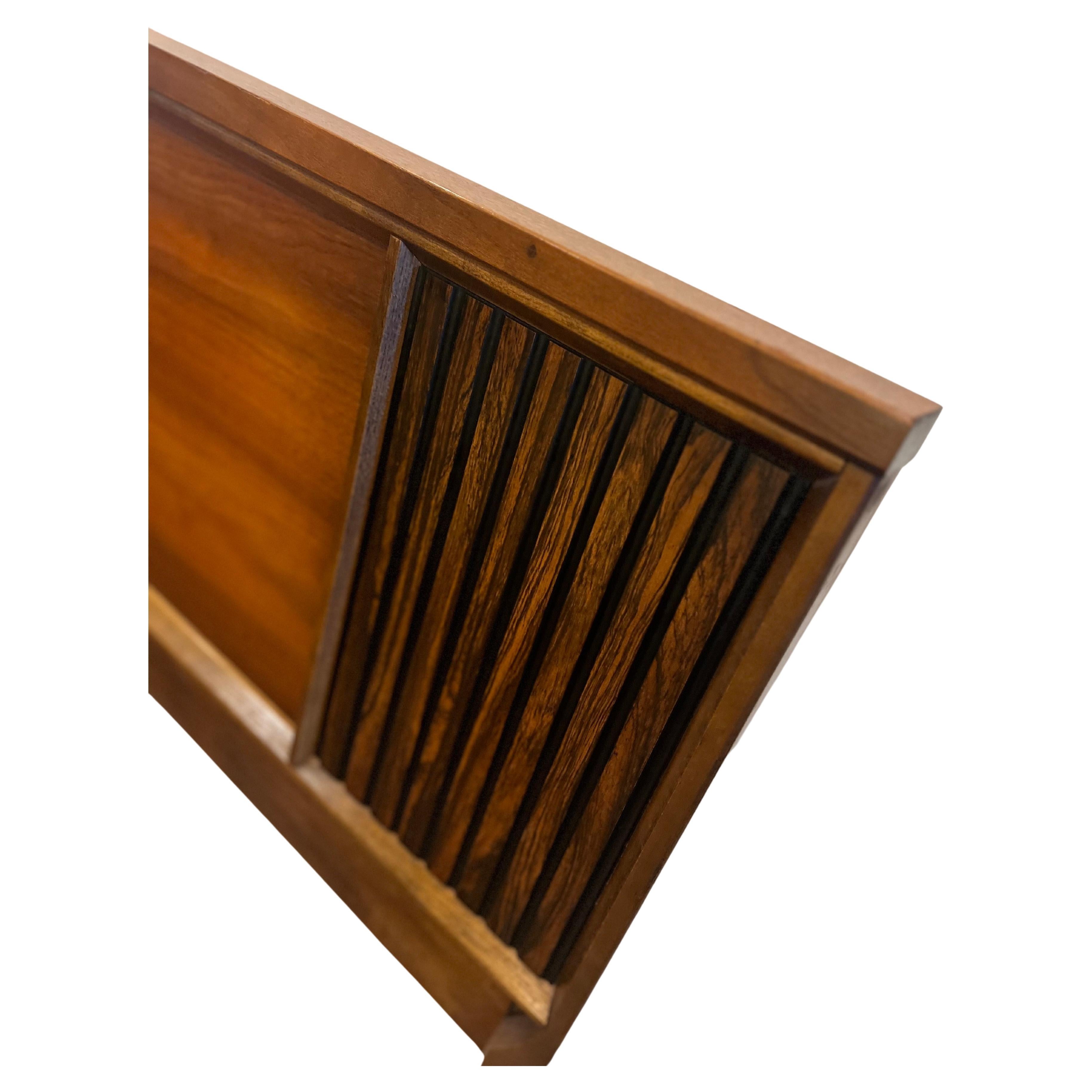 Elevate your bedroom to new heights of elegance with this rare and exquisite American Mid-Century Walnut Headboard, featuring striking rosewood inserts, crafted by Lane Furniture circa the 1960s. This king-size headboard is not just a piece of