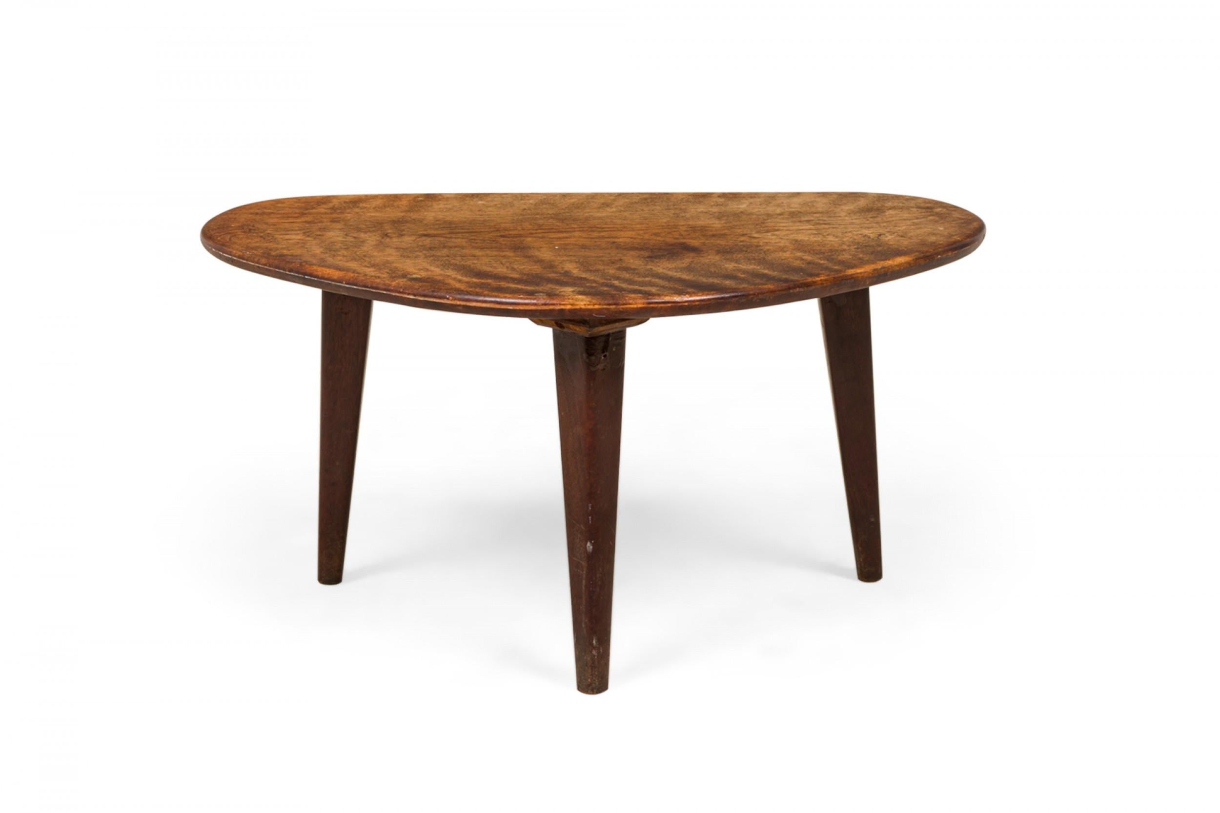 American mid-century walnut occasional table with a triangular top with rounded corners, resting on three squared and tapered legs.