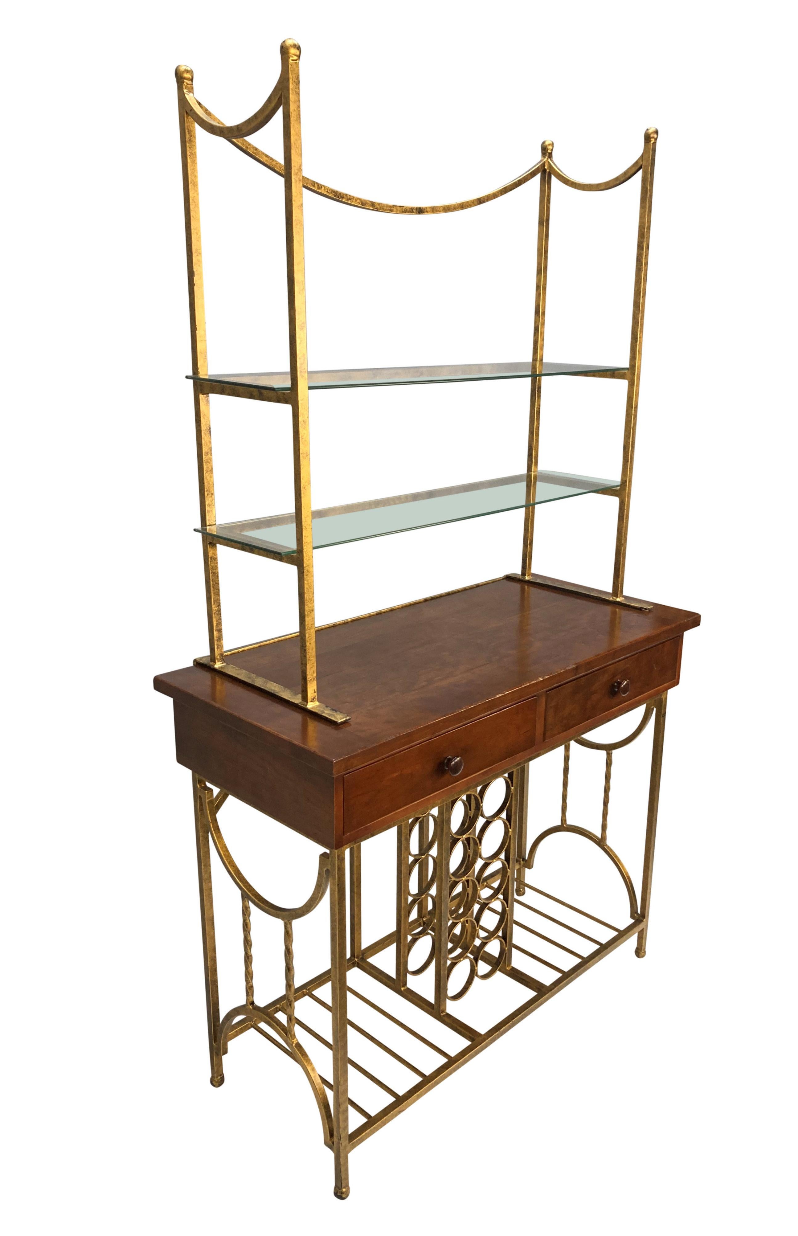 An American Mid-Century dry bar in gilt iron and cherry wood, with two drawers, bottle rack and two glass shelves.