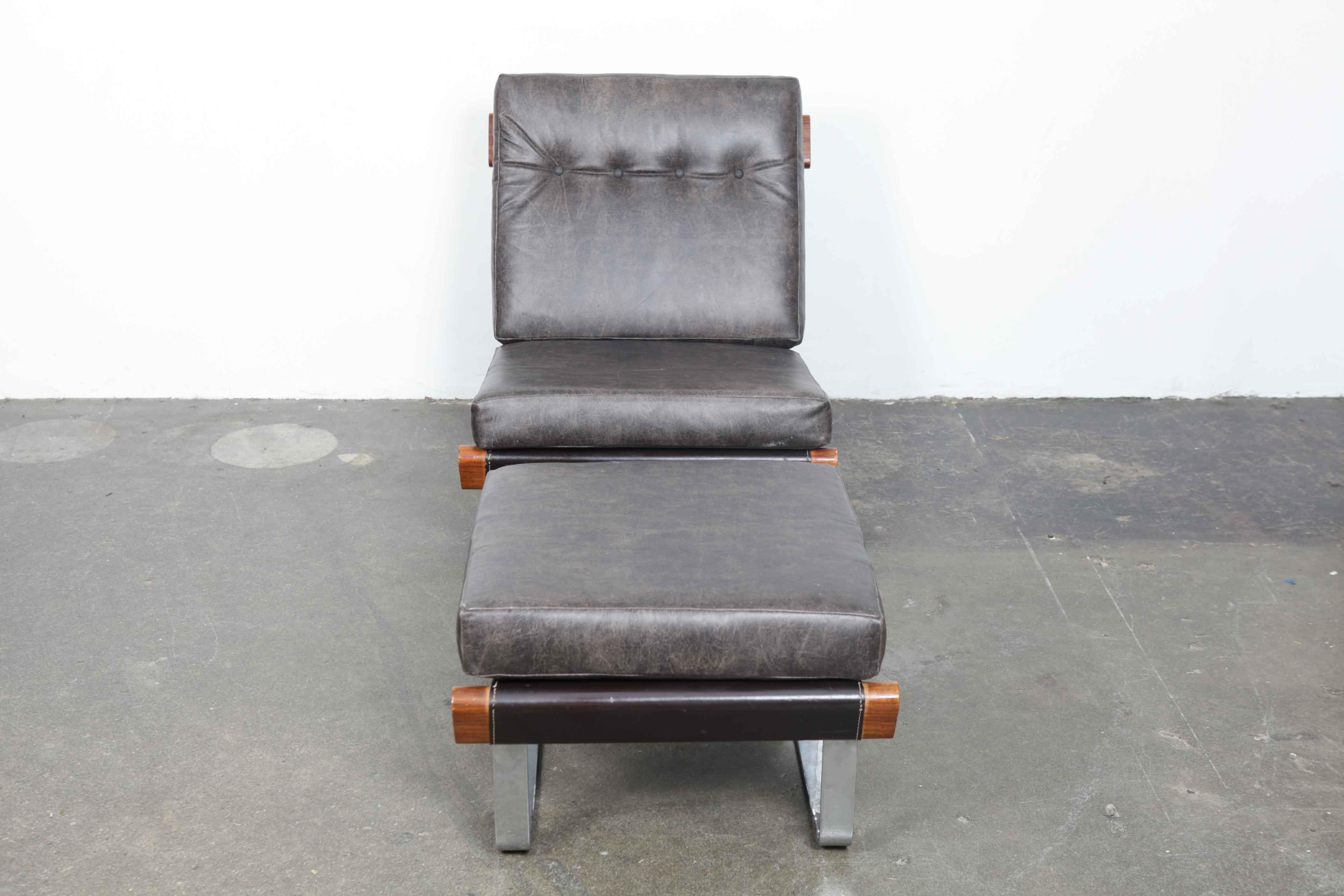Tufted leather 1970s lounge chair with ottoman with metal and wood frame. Newly upholstered in leather, most likely made in USA. (Ottoman measures: W 24 x D 21.75 x H 17).