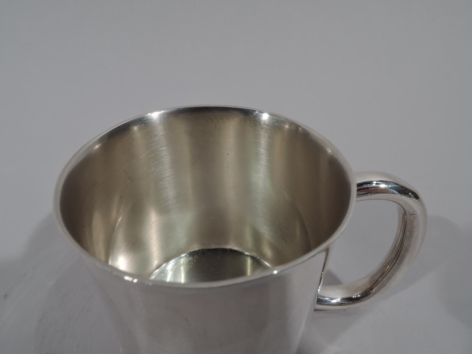 American Mid-Century Modern sterling silver baby cup. Made by Towle in Newburyport, Mass. Drum form with gently flared rim and thick c-scroll handle. Lots of room for engraving. Fully marked and numbered 7871. Weight: 3.4 troy ounces.