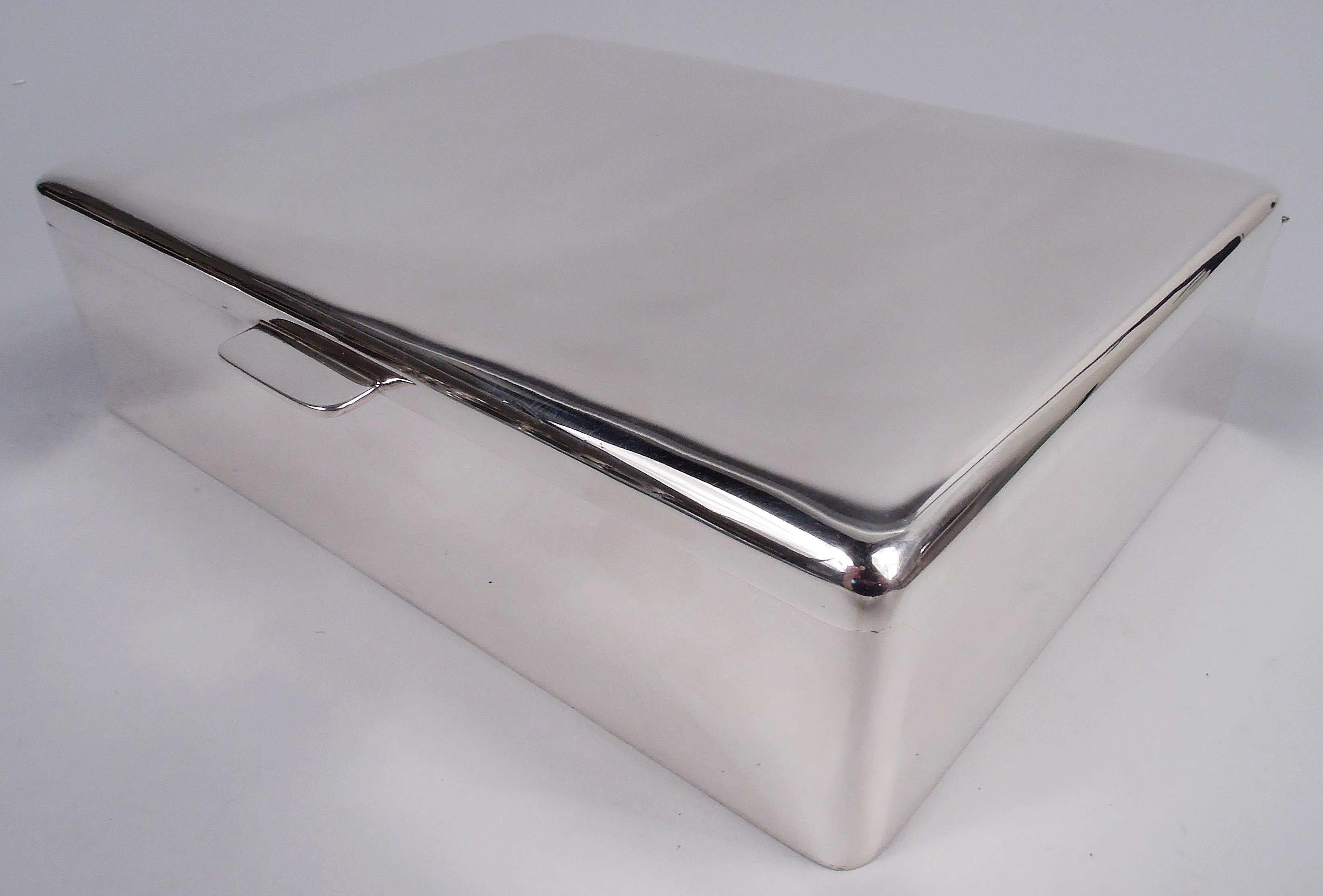 Midcentury Modern sterling silver box. Made by JC Boardman & Co. in Connecticut. Rectangular with straight sides and curved corners. Cover hinged with gently curved top and rectangular tab. Fully marked including maker’s stamp and no. 845. Heavy