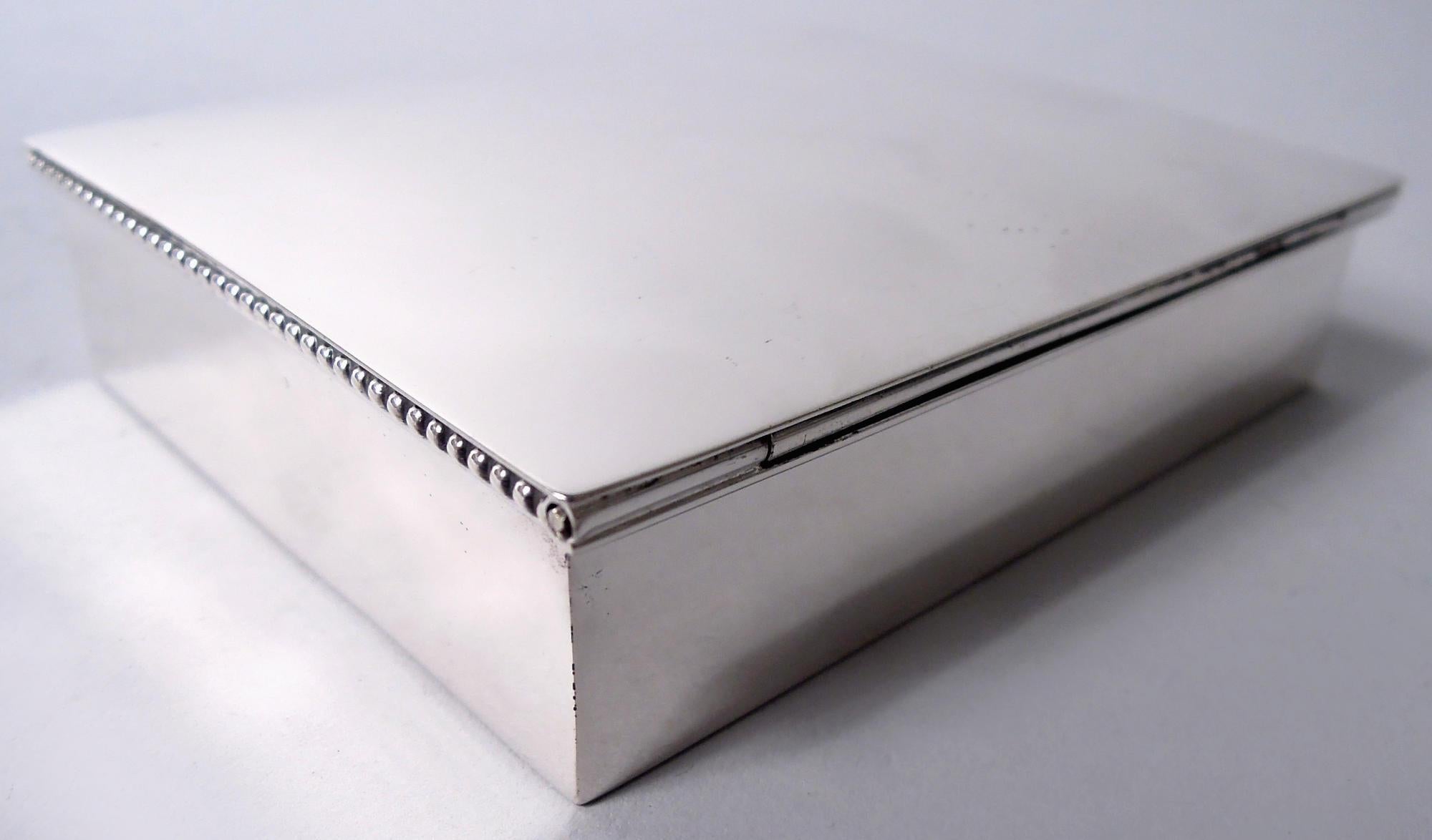 Midcentury Modern sterling silver box. Made by Becht & Hartl, Inc. in Newark. Rectangular with straight sides and beaded rim. Cover hinged and gently curved. Box interior cedar lined. Fully marked including maker’s stamp and no. 8/1. Gross weight: