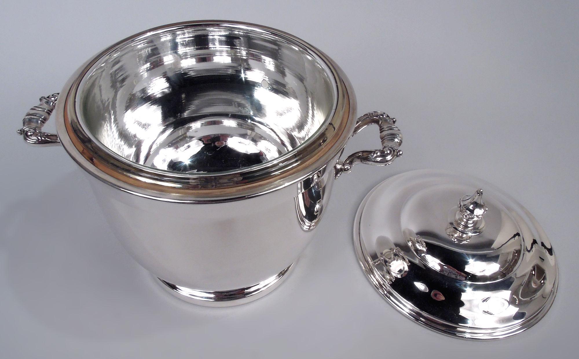 Midcentury Modern sterling silver ice bucket. Urn with scroll-bracket side handles and raised foot. Cover doubled domed with vasiform finial. Thermos-insulated interior. Fully marked including maker’s stamp (Poole) and no. 55. 