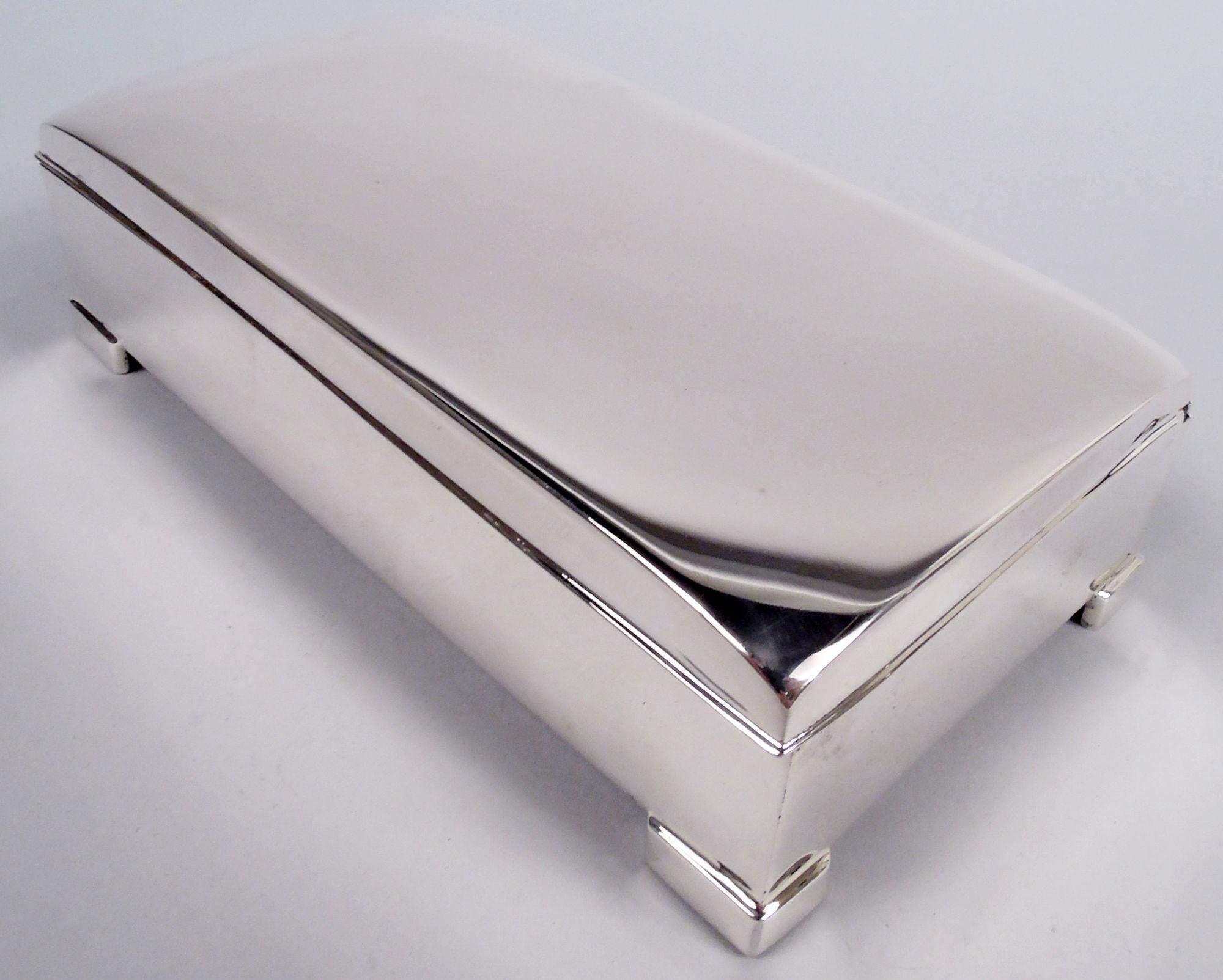 Midcentury Modern sterling silver keepsake box. Made by Poole in Taunton, Mass. Rectangular with straight sides on corner bracket supports. Cover hinged with curved top and flat and narrow rim. Box interior velvet lined. Fully marked including