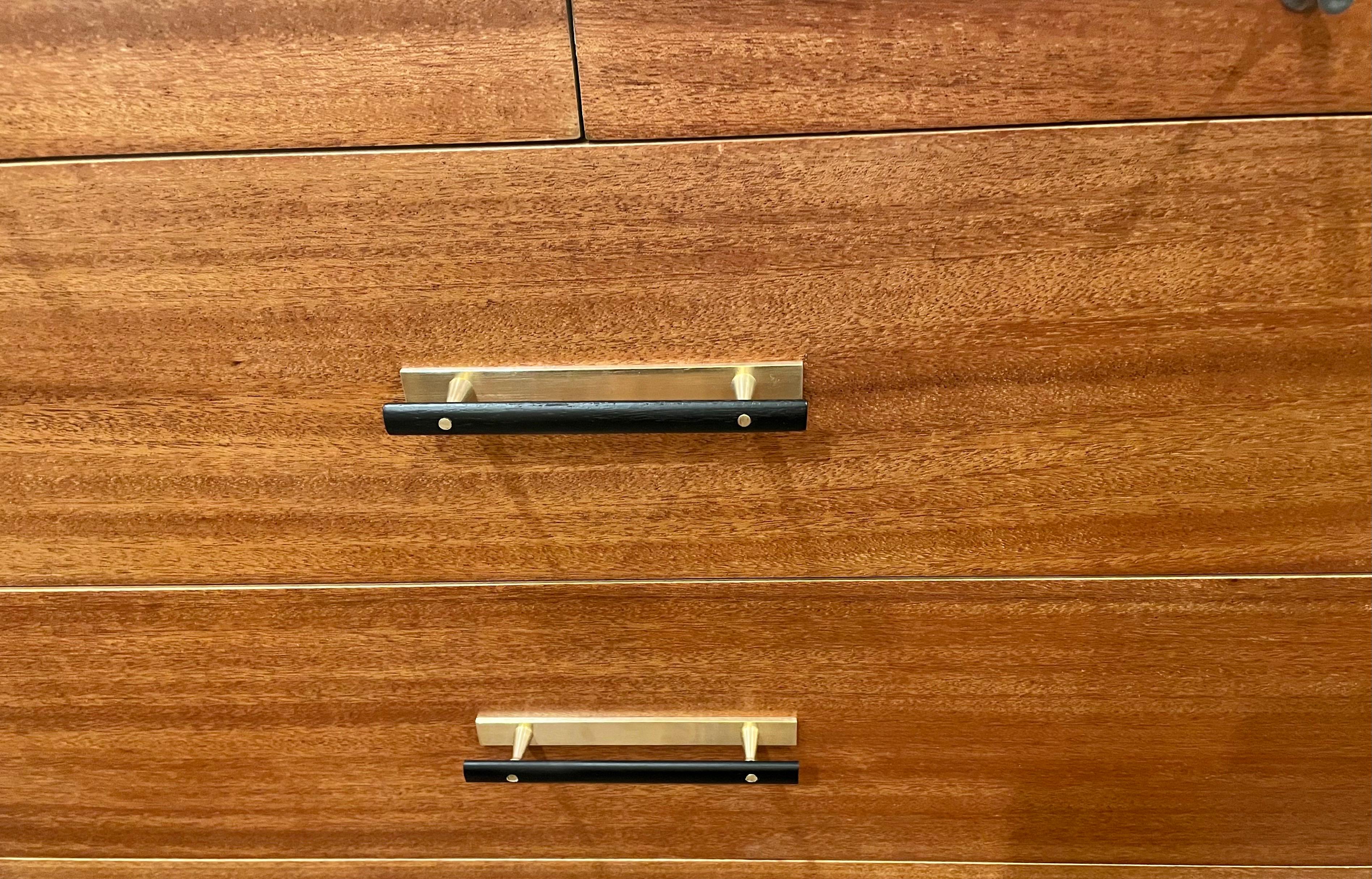 Beautiful elegant dressers designed by Paul McCobb, part of the Calvin group Directional Designs, polished brass legs with rare bowtie handles, in black lacquer finish freshly refinished and polished. buyer has the option to buy one or two price its