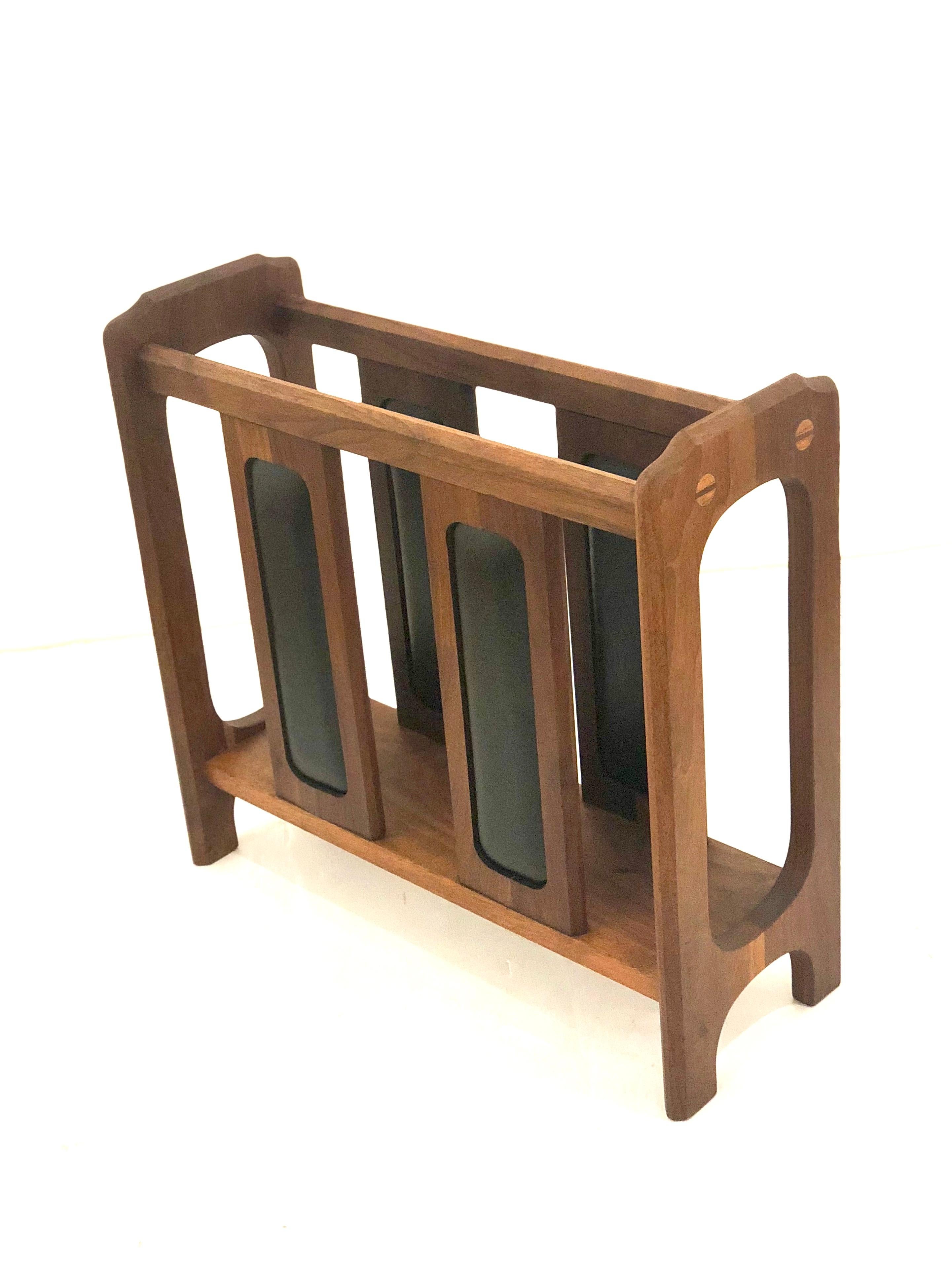 Beautiful and rare solid walnut magazine rack, we believe it was design by Arthur Umanoff, freshly refinished, California design. Incredible craftsmanship and detail with black Naugahyde decorative inserts.
