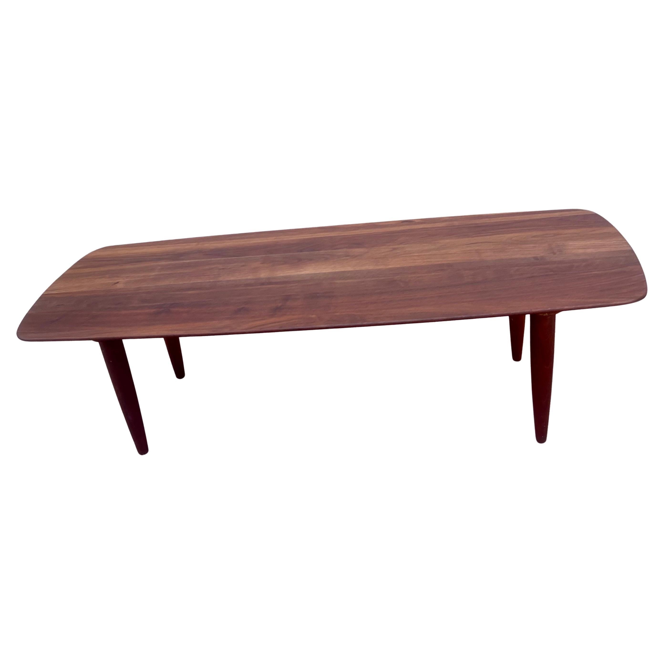 Beautiful grain on this solid American walnut surfboard coffee table, with rounded beveled edge by Ace of California, solid and sturdy freshly refinished, great design practical piece. Legs are removable for easy shipping.