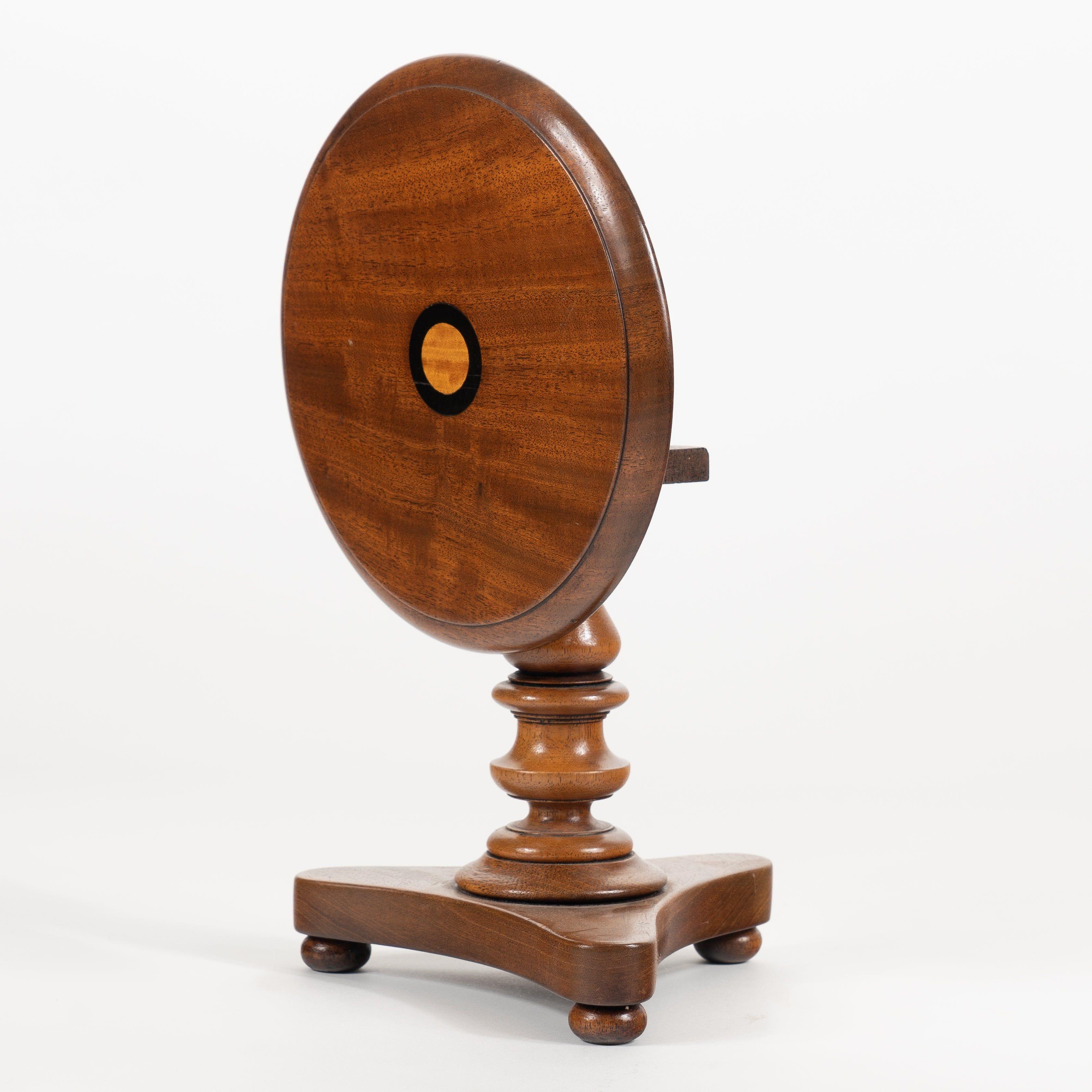Miniature mahogany Classic Revival tilt top circular pedestal table or candle stand.
Attributed to Thomas Clowney, Mineral Point, Wisconsin.

America, circa 1840.

Materials: Mahogany
Dimensions: 8” W x 8