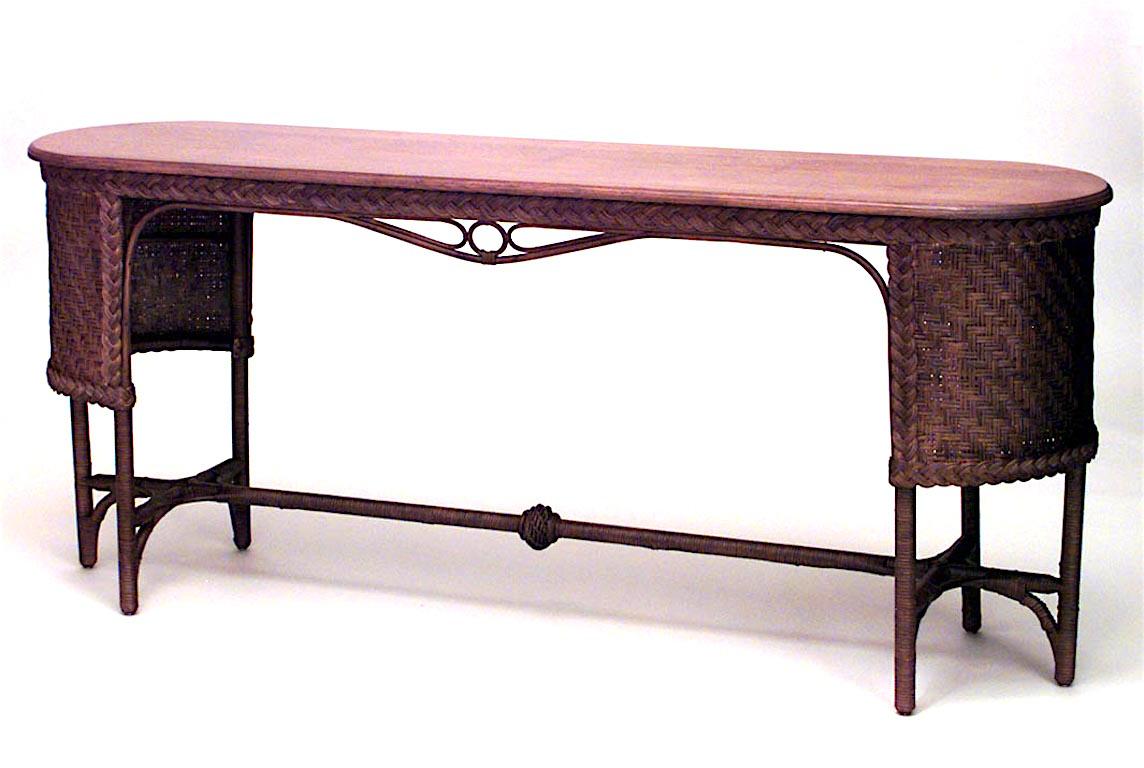 American Mission natural wicker davenport table with rounded woven side panels and braided apron with stretcher and oval oak top. (attributed to HEYWOOD WAKEFIELD)
