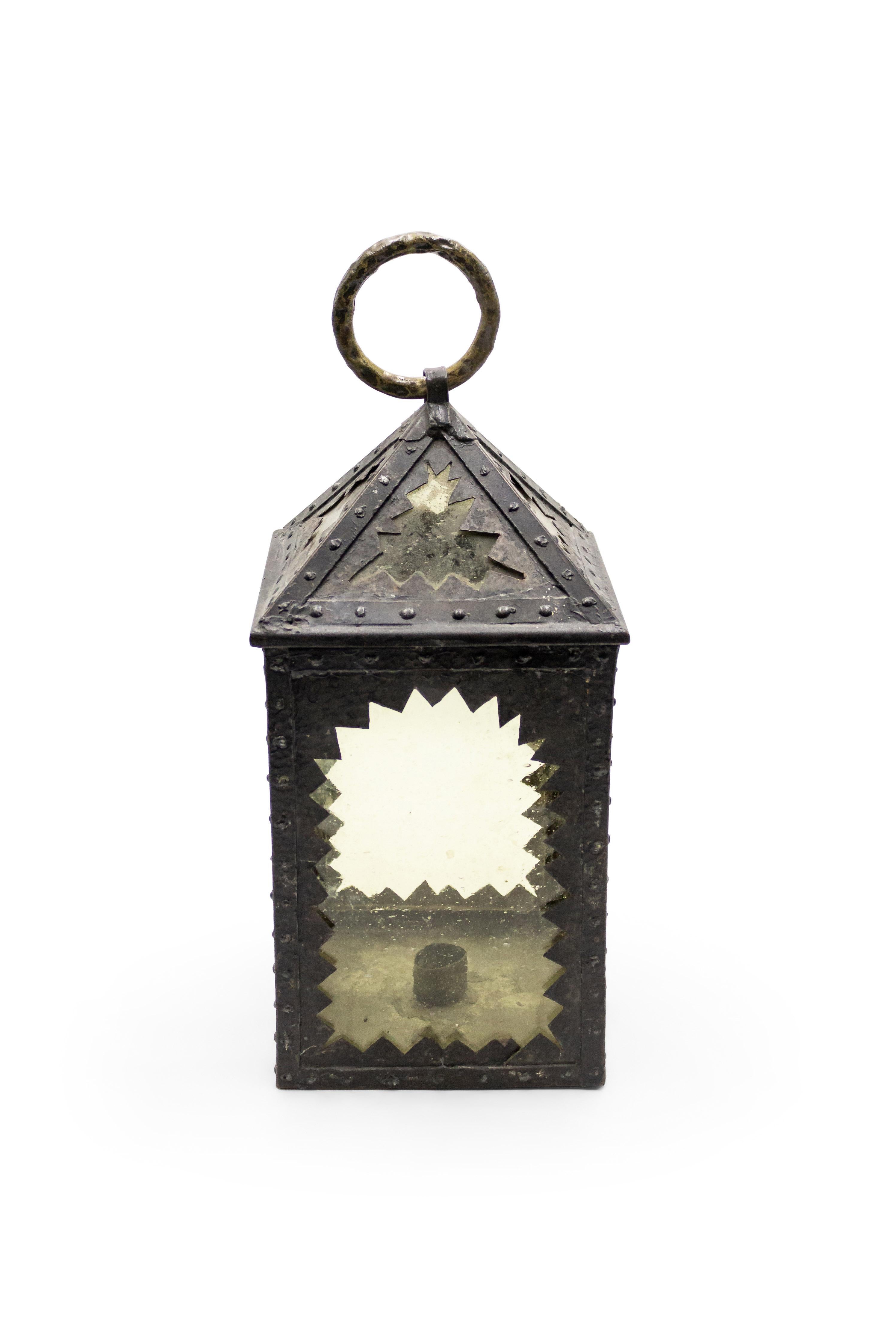 American mission square wrought iron hand lantern with amber glass inset into sawtooth design framed panels with brass ring top.