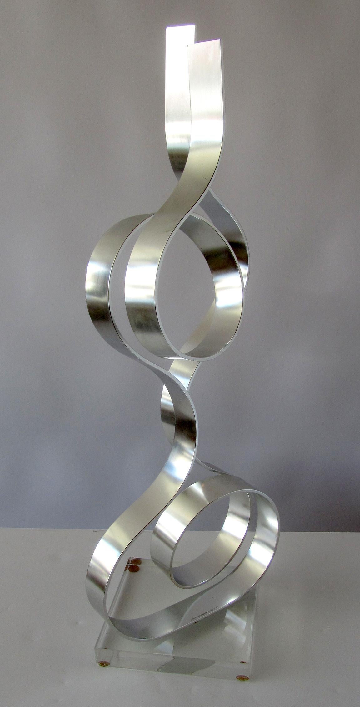 This extraordinary sculpture is one band of polished steel twisted and manipulated into this form.