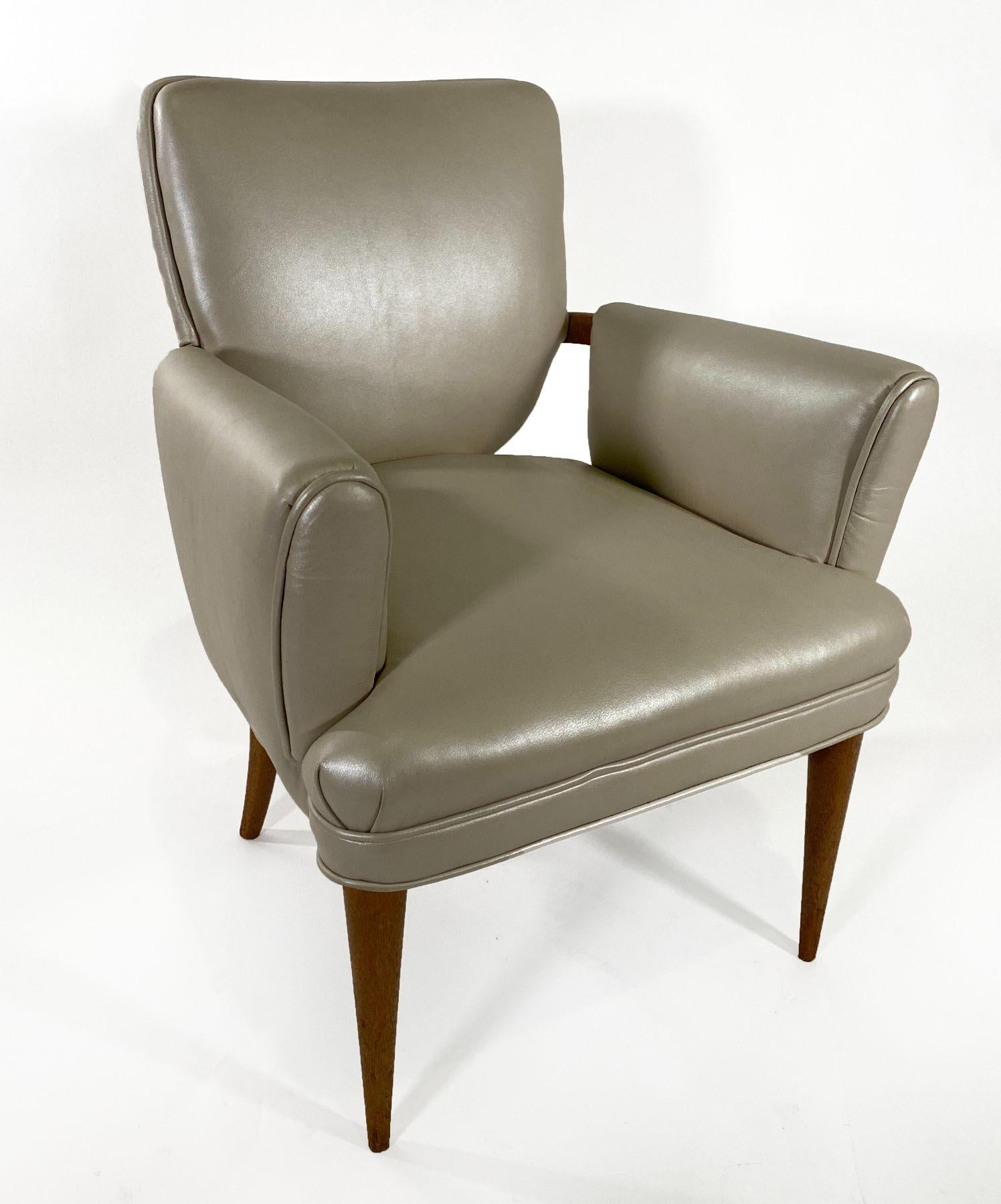 The tear drop shaped back and fully upholstered sides in cream leather, with bleached mahogany legs and arms.
 