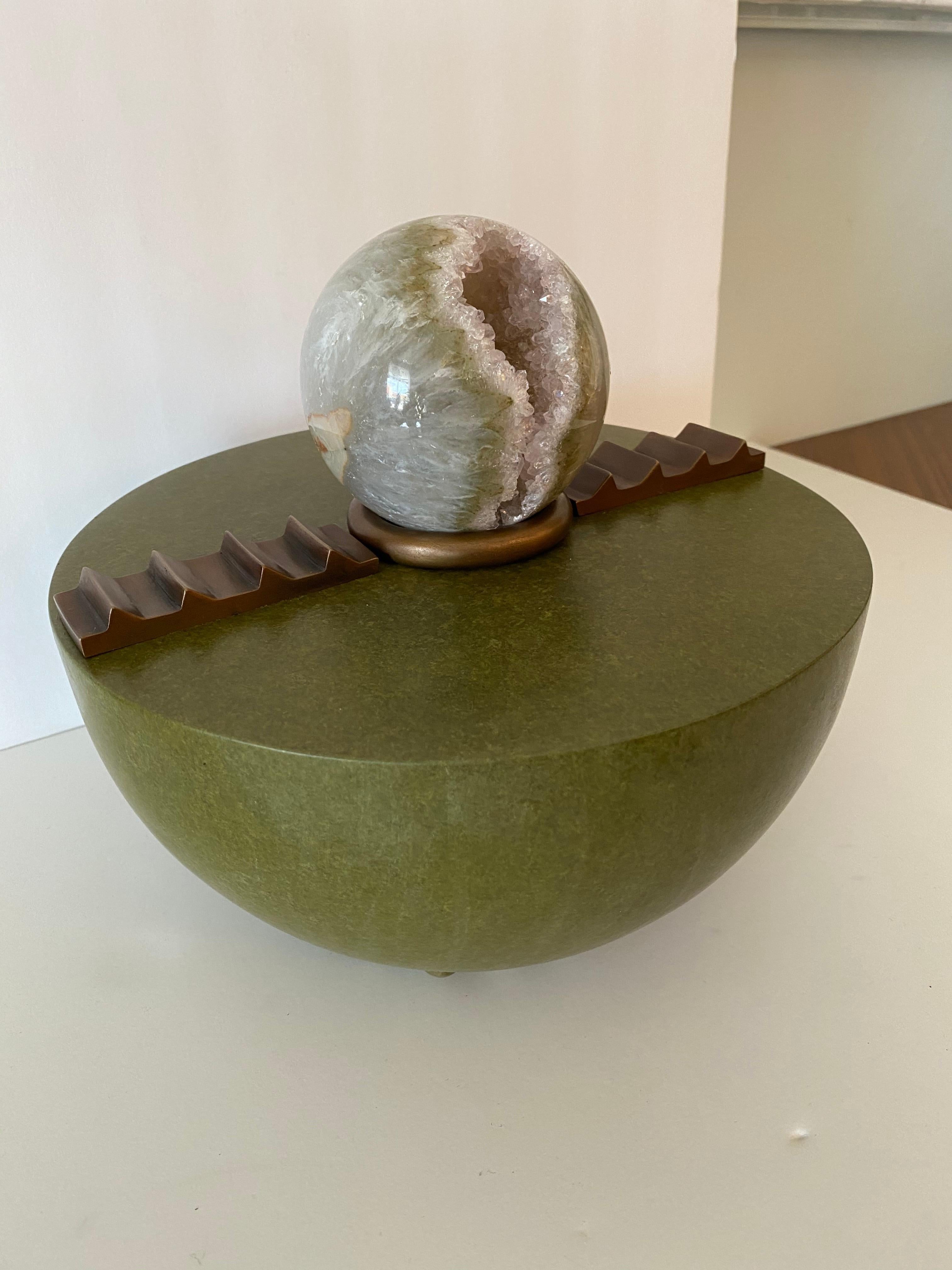 An American modern sculpture by Korean Born artist Hyunae Kang. The amethyst orb sits upon a patinated bronze circular base that is signed on the bottom. Textured geometrical shapes also add additional texture to the piece.