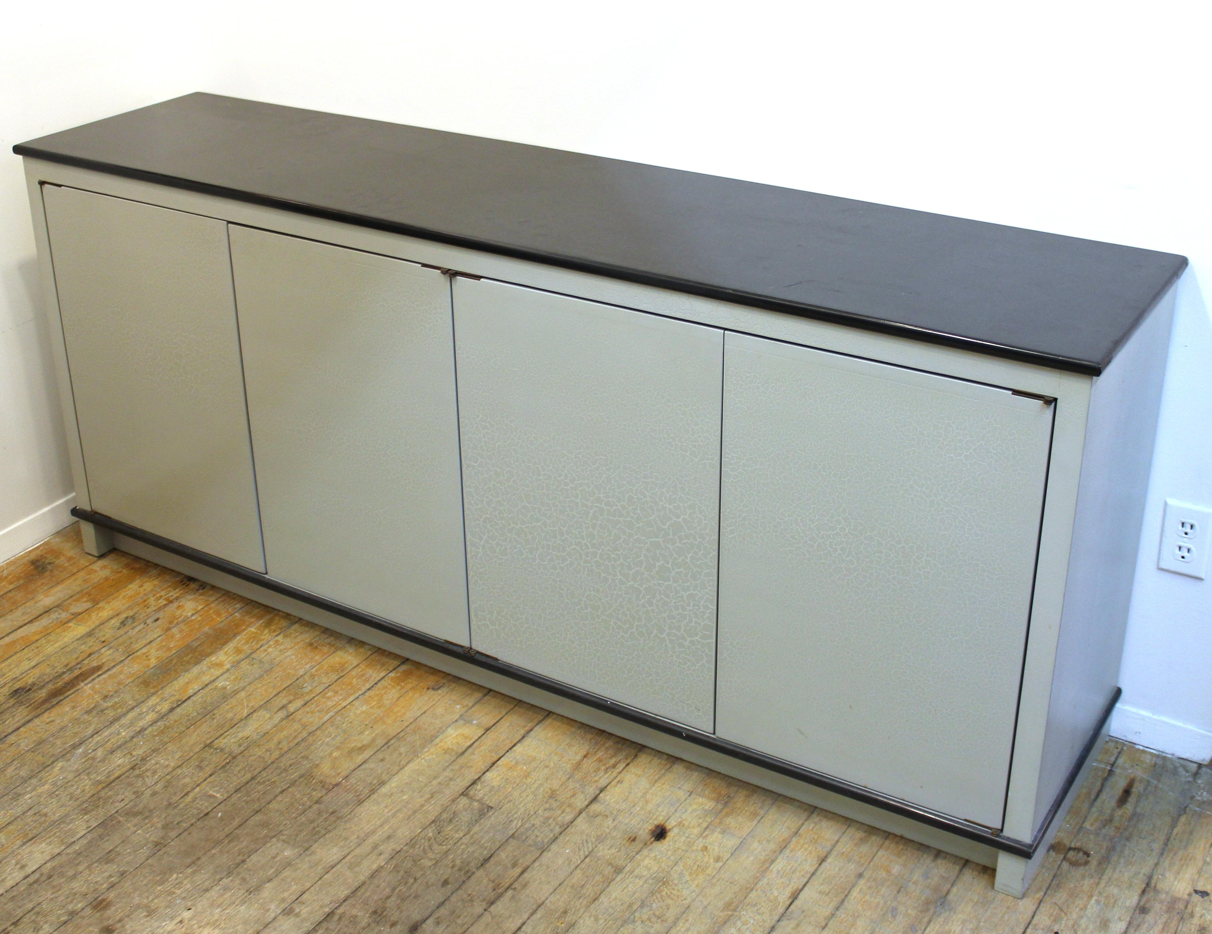 American Modern storage cabinet with craquelure surface. The piece has four hinged doors with a grey craquelure surface and a black top. It was likely made during the 1980s in the United States and is in great vintage condition, with some