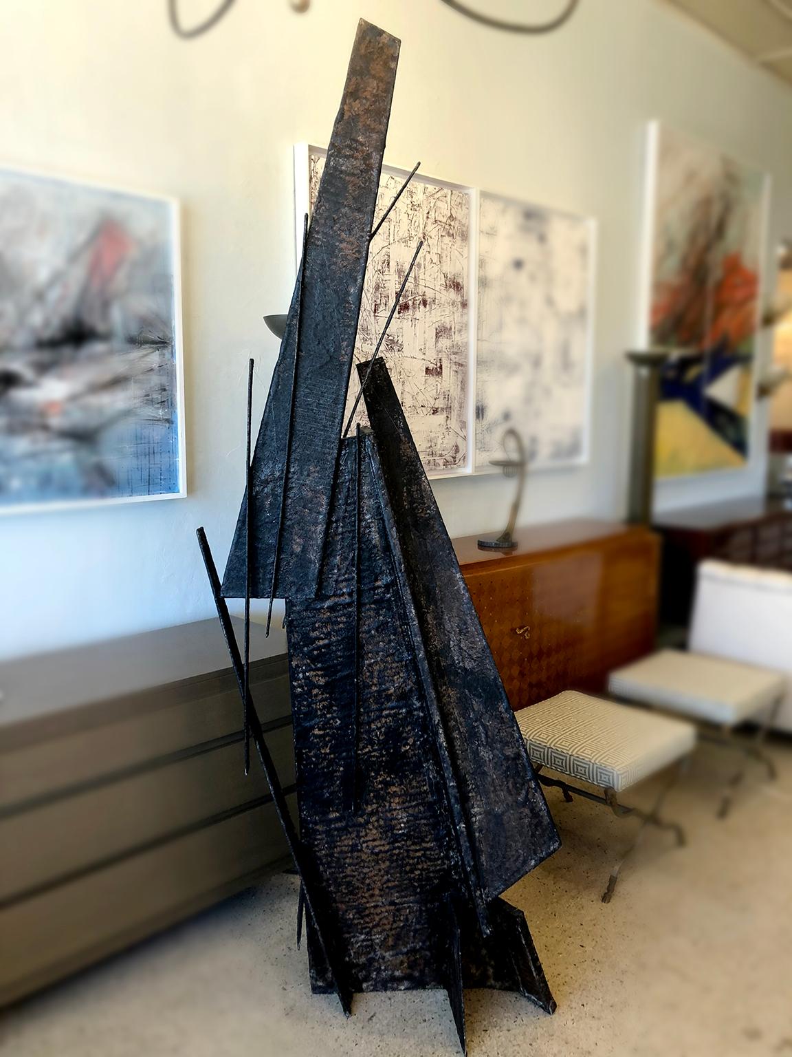 An imposing sculpture made of Fiberglass and painted to resemble patinated bronze. The piece takes on a different shape from all sides. Constructed in fiberglass, it is lightweight, so the piece can be turned to view it from many different
