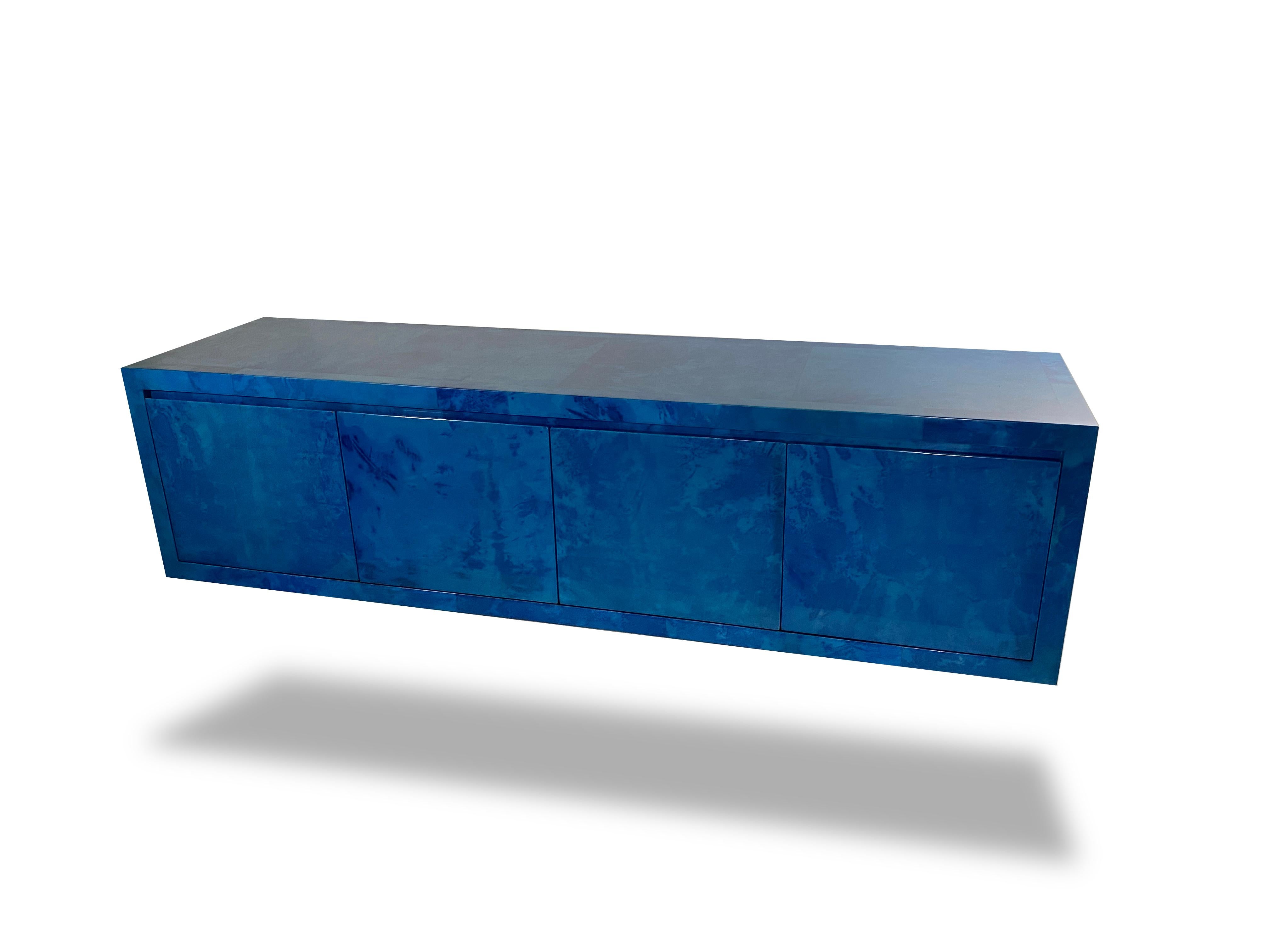 We are authorized reps on Karl Springer LTD. A Lapis goatskin 4 door server/credenza, each door opens to reveal a drawer and shelves. We can custom create this piece in 12 colorways and size. Handpolished poly-lacquered with a cerused interior