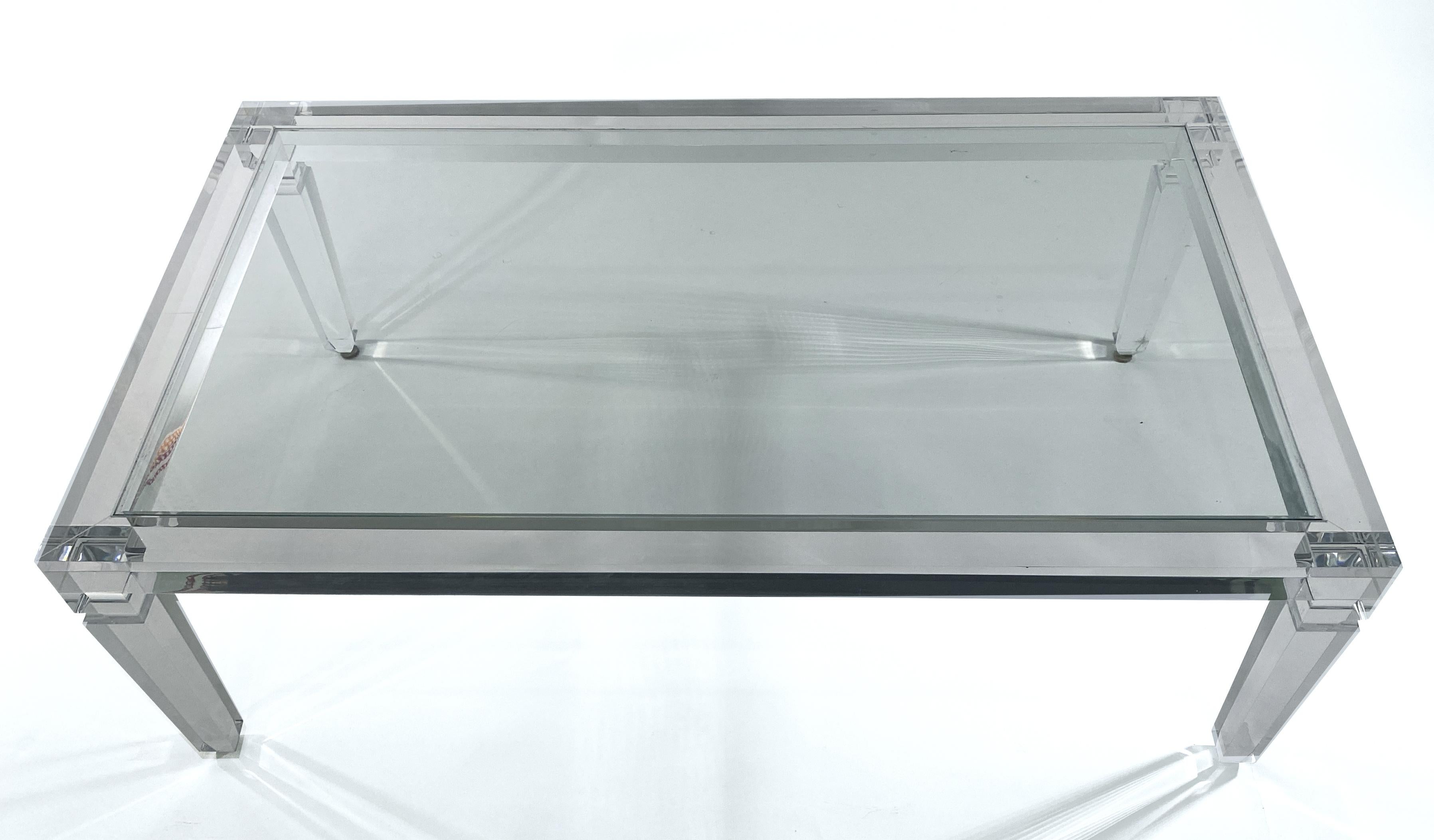 An American Modern Lucite Coffee table by Lucite artist Charles Hollis Jones.
The rectangular table is highlighted by neoclassical legs that resemble glass. The glass top is inset into the table for both safety and comfort.
This table is