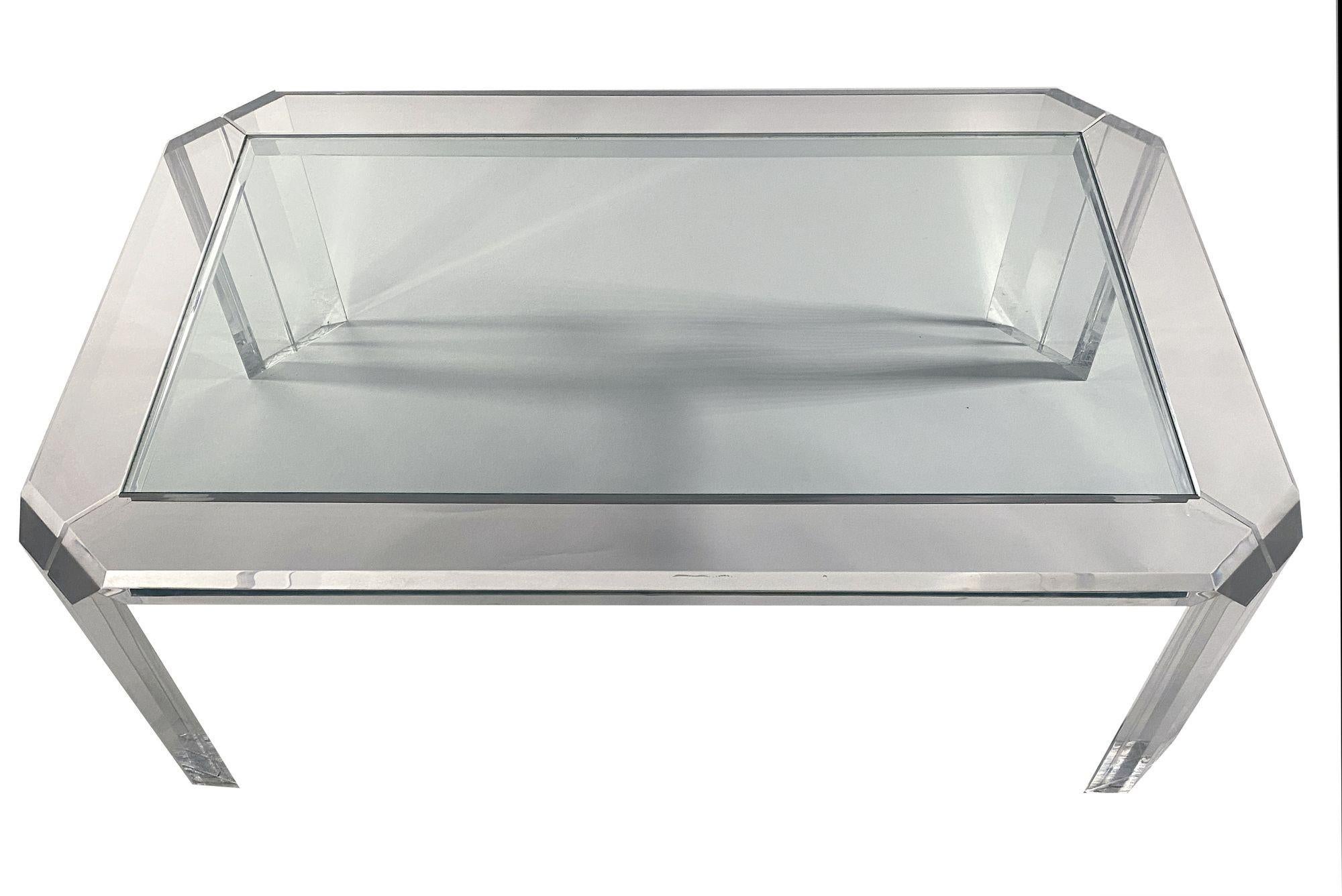 Americam modern rectangular cocktail table. By lucite artist Charles Hollis Jones.
The rectangular table with faceted corners to give it a softer appearance.
Glass is inset into the lucite frame for safety and convenience.