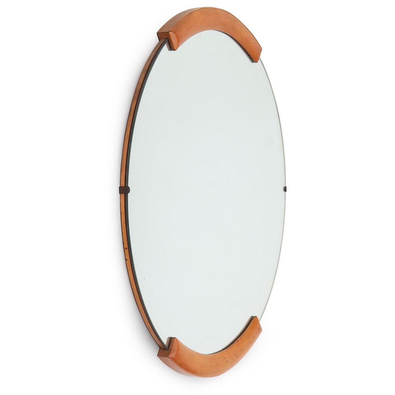 A simple modern maple-accented wall mirror from Russel Wright's seminal American Modern furniture line. Mirror in vintage condition, replacement recommended. Please inquire for lead time.