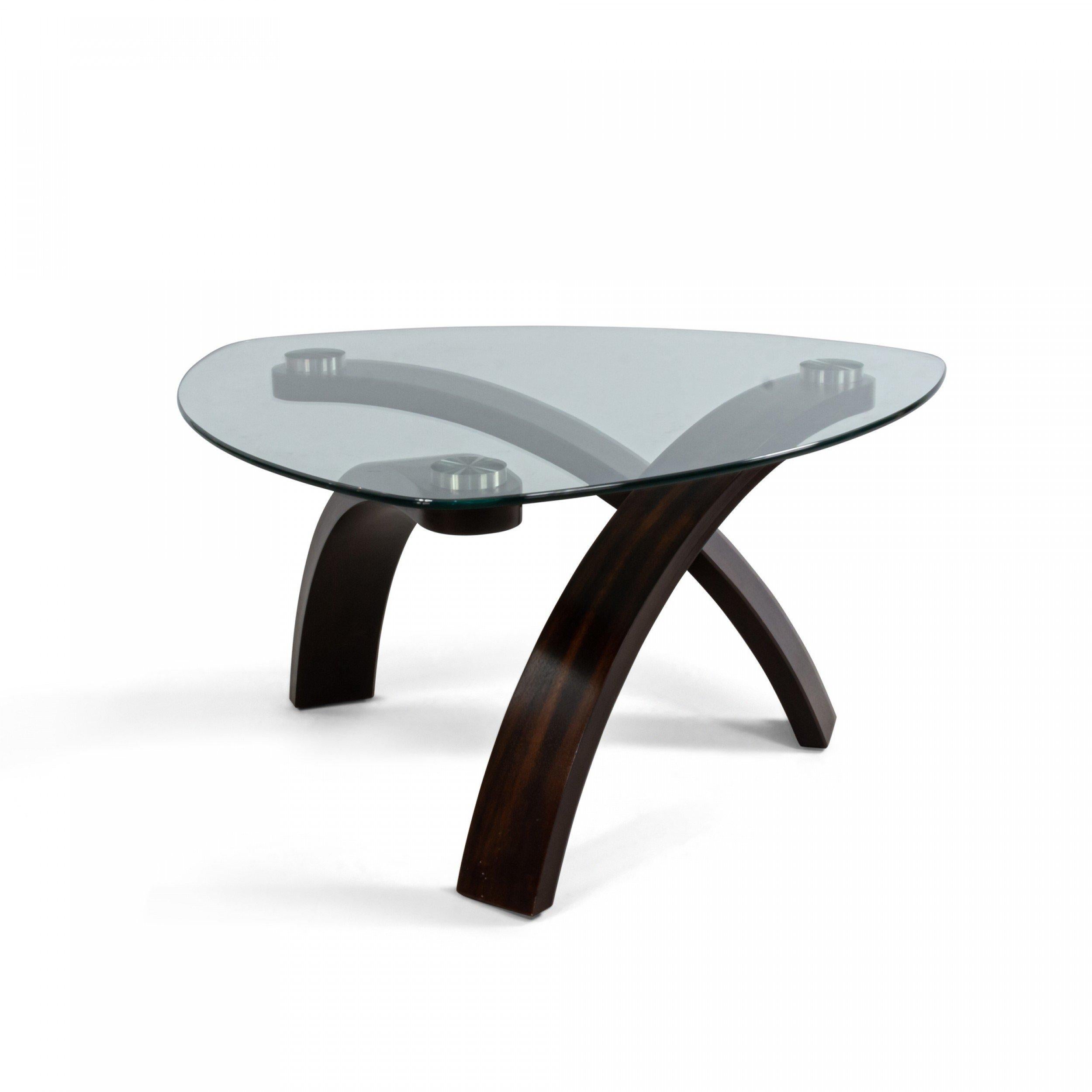 American Modern coffee table with three molded dark wood legs and a three-sided glass top.
 