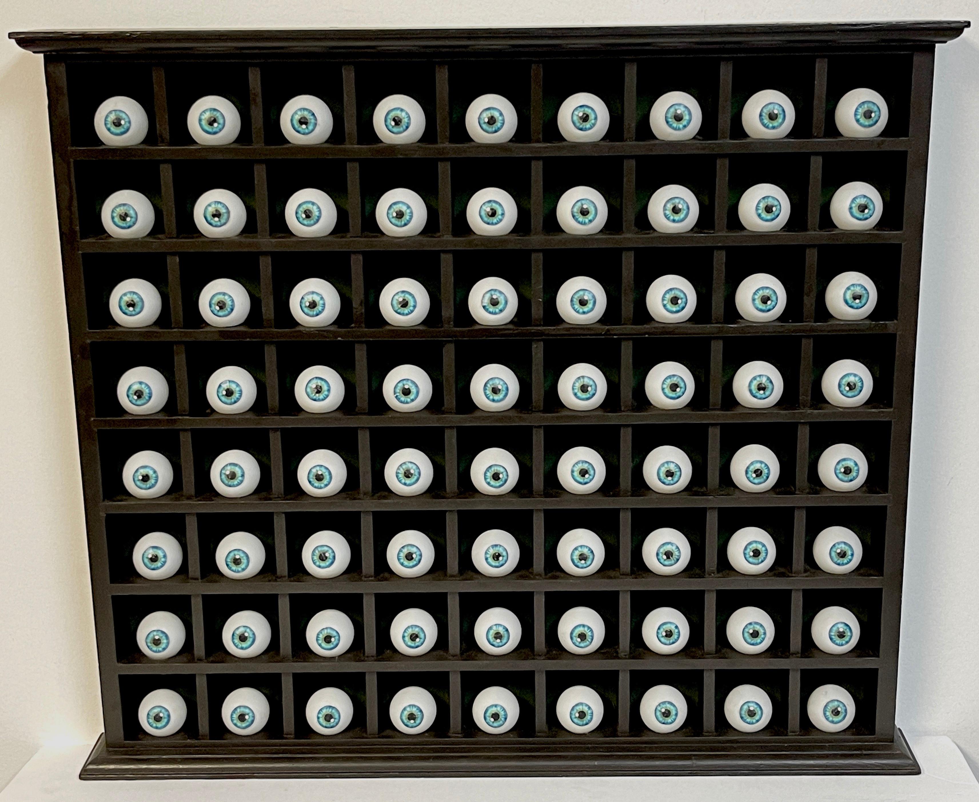 American modern outsider art wall sculpture '72 Blue Irises'

A unique wall sculpture of 72 Blue Irises, shelved. Unsigned
Presenting a symmetrical perspective of repetitive three dimensional ophthalmology related sculpture. 
Each individual