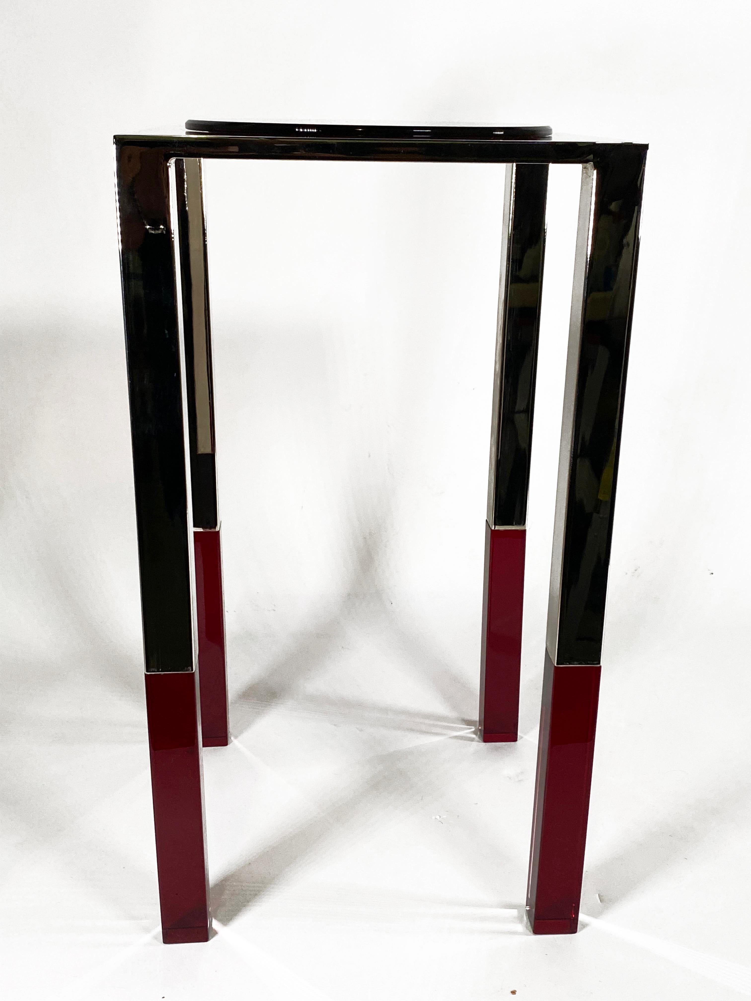 Unique side table design by Charles Hollis Jones .
Finished in polish chrome with a decorative lucite circle top plate in Red. This table is a limited edition and will only have 12 produced. We are exclusively selling this table for Charles Hollis