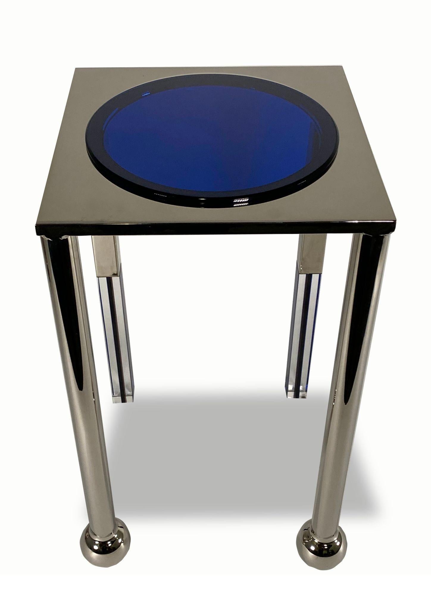 Unique side table design by Charles Hollis Jones.
Finished in polish chrome with a decorative lucite circle top plate in blue. Production is limited to 12 pieces, and is a limited run. Clients can buy one table, or one pair. We are the exclusive