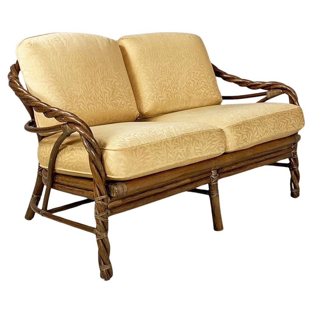 American modern rattan and beige floreal fabric sofa by McGuire Company, 1970s For Sale