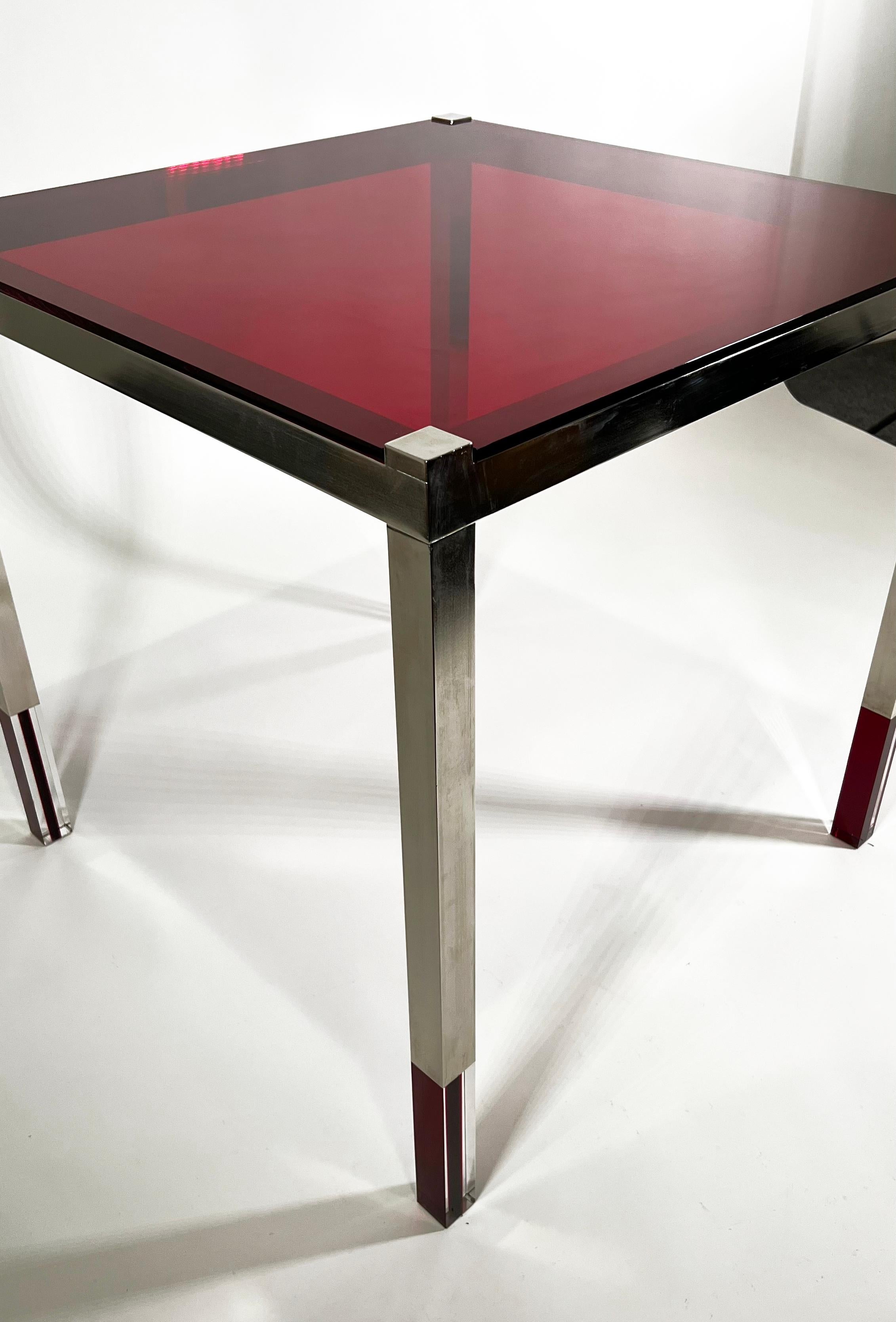 The red lucite top above a framework mixed with nickel, clear, and red lucite elements- This is part of Charles Hollis Jones New Colored Lucite Line, which we exclusively represent- we can have this table created in blue, yellow, and orange Lucite