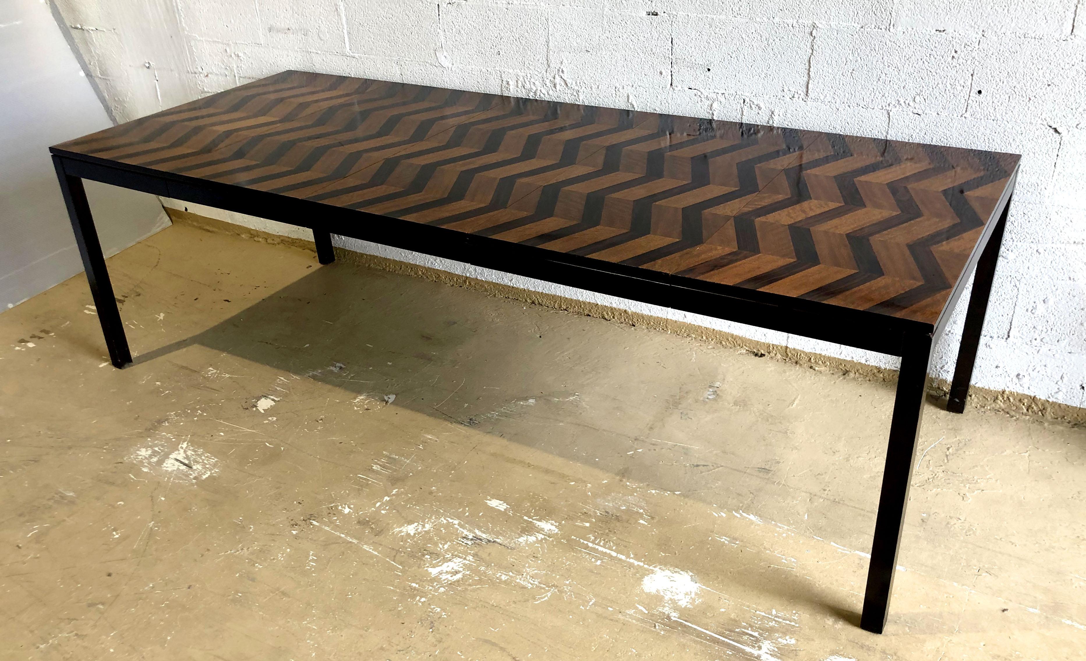 The top with inlaid chevron pattern, with extension leaves, over ebonised parsons legs- this rare model table was created for directional furniture company in 1978.