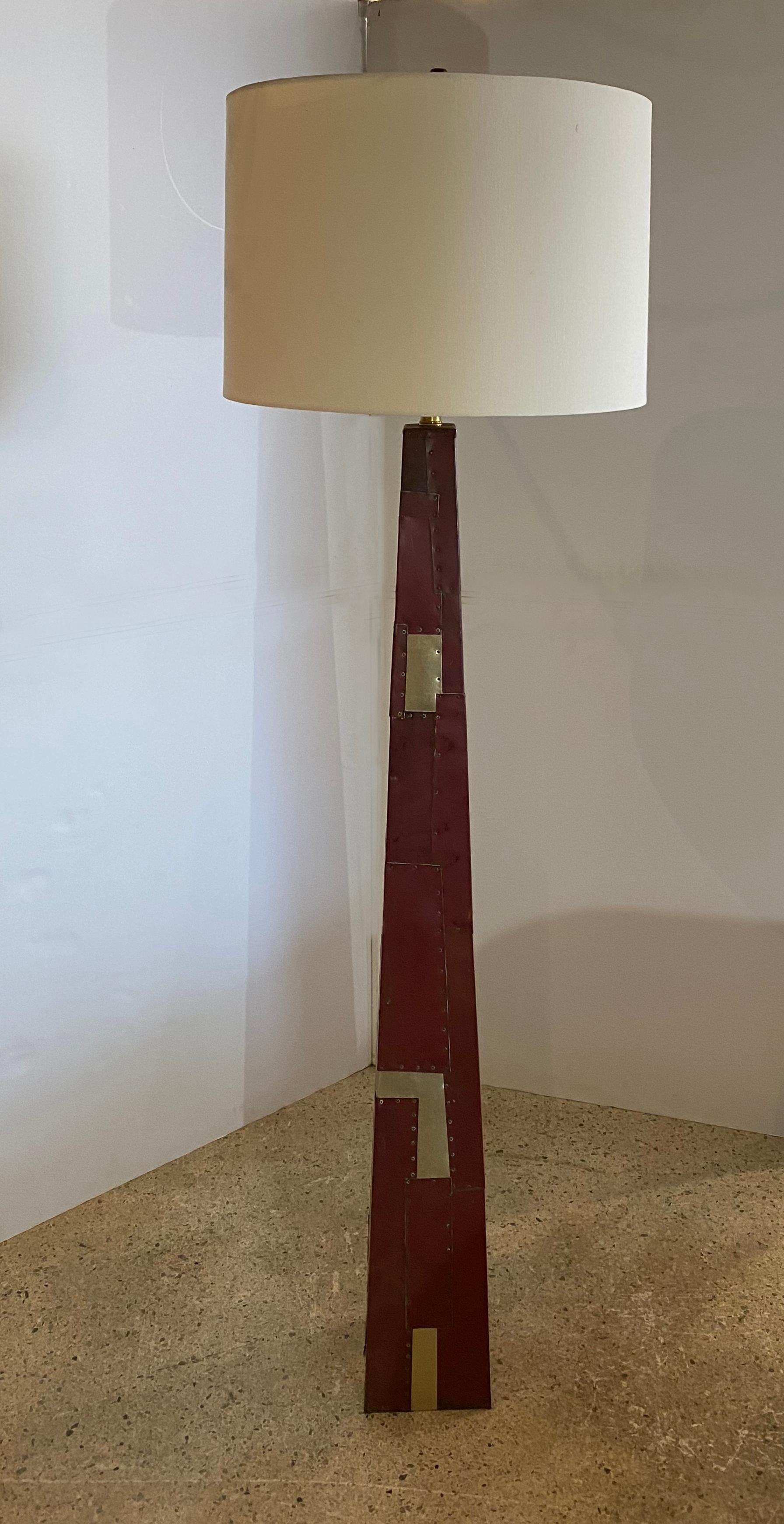 American modern floor lamp by Tony Berlant, The imposing floor lamp is made of metal sheeting, some painted 
and wrapped around the base and applied by rivets. Inserts of contrasting metal sheeting have been applied to give the base
visual