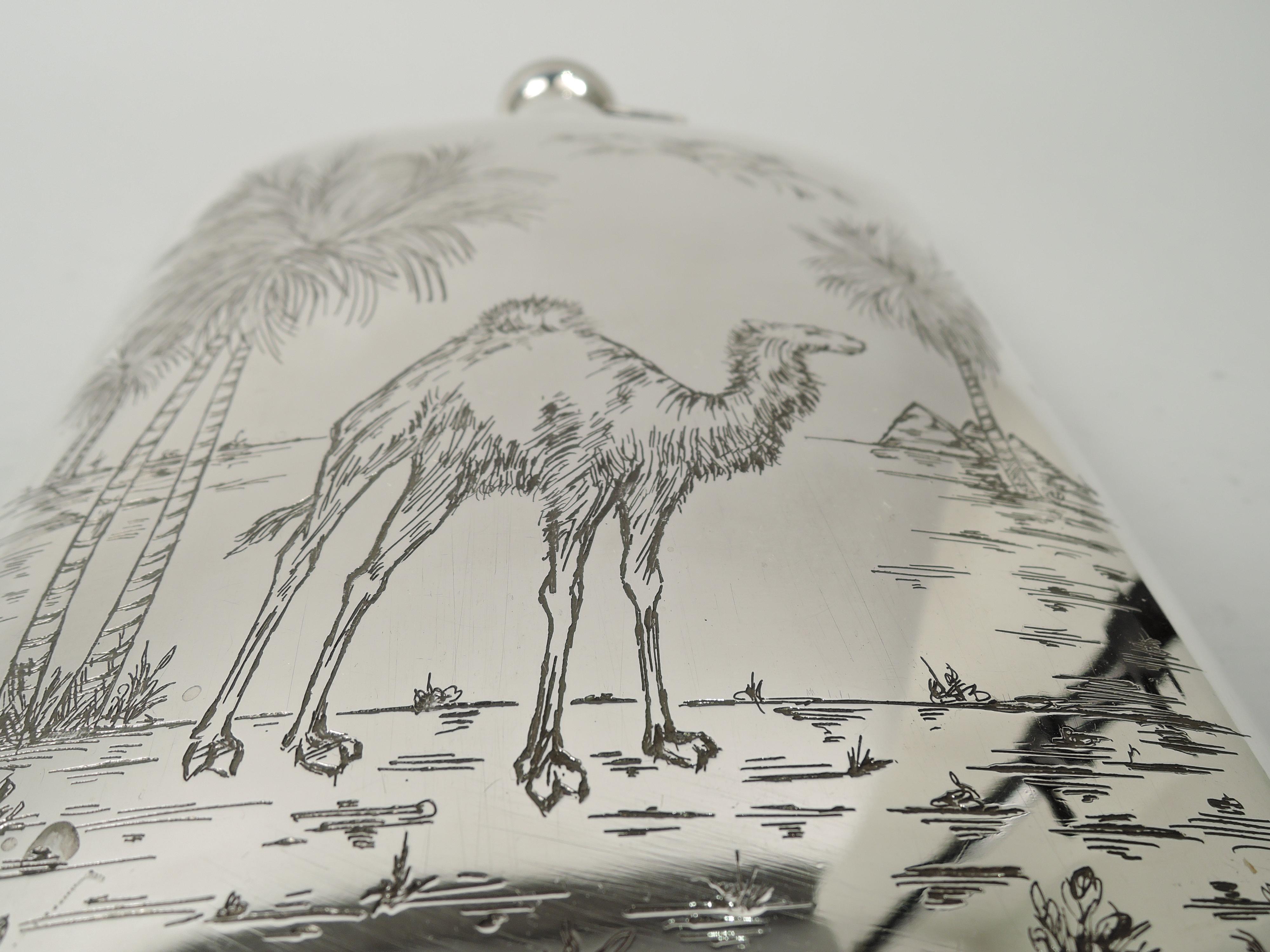 American Modern sterling silver flask, ca 1920. Rectilinear and curved; cover hinged, threaded, and cork-lined. Front engraved with a camel, a paragon of drought survival, standing on parched ground with scattered shoots of greenery. In background